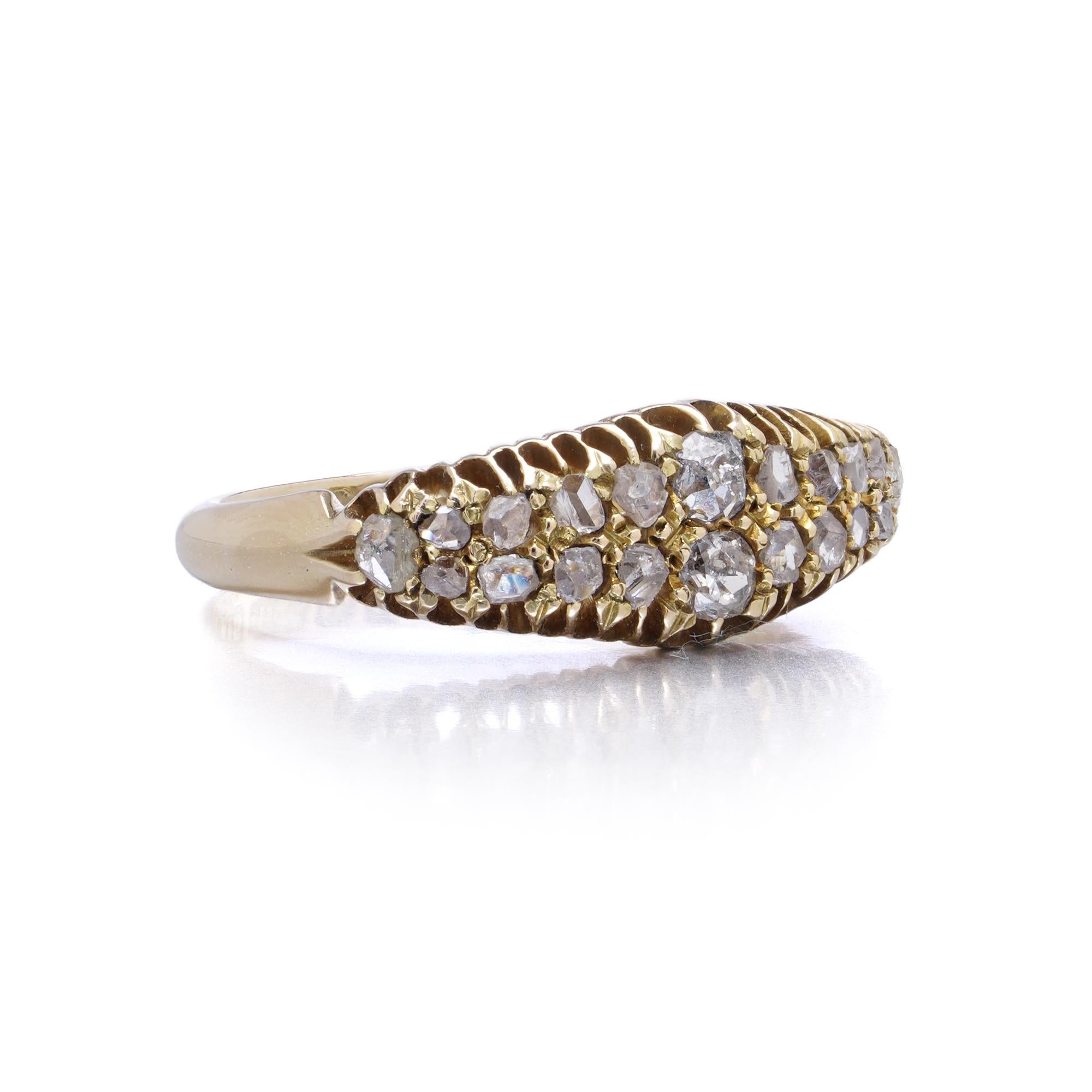 A finely crafted antique 15kt yellow gold ring set with twenty rose-cut diamonds in a graduated bombe-style setting. The diamonds are pavé-set into a textured gold band with a softly domed profile, lending an organic yet refined elegance. Hallmarked