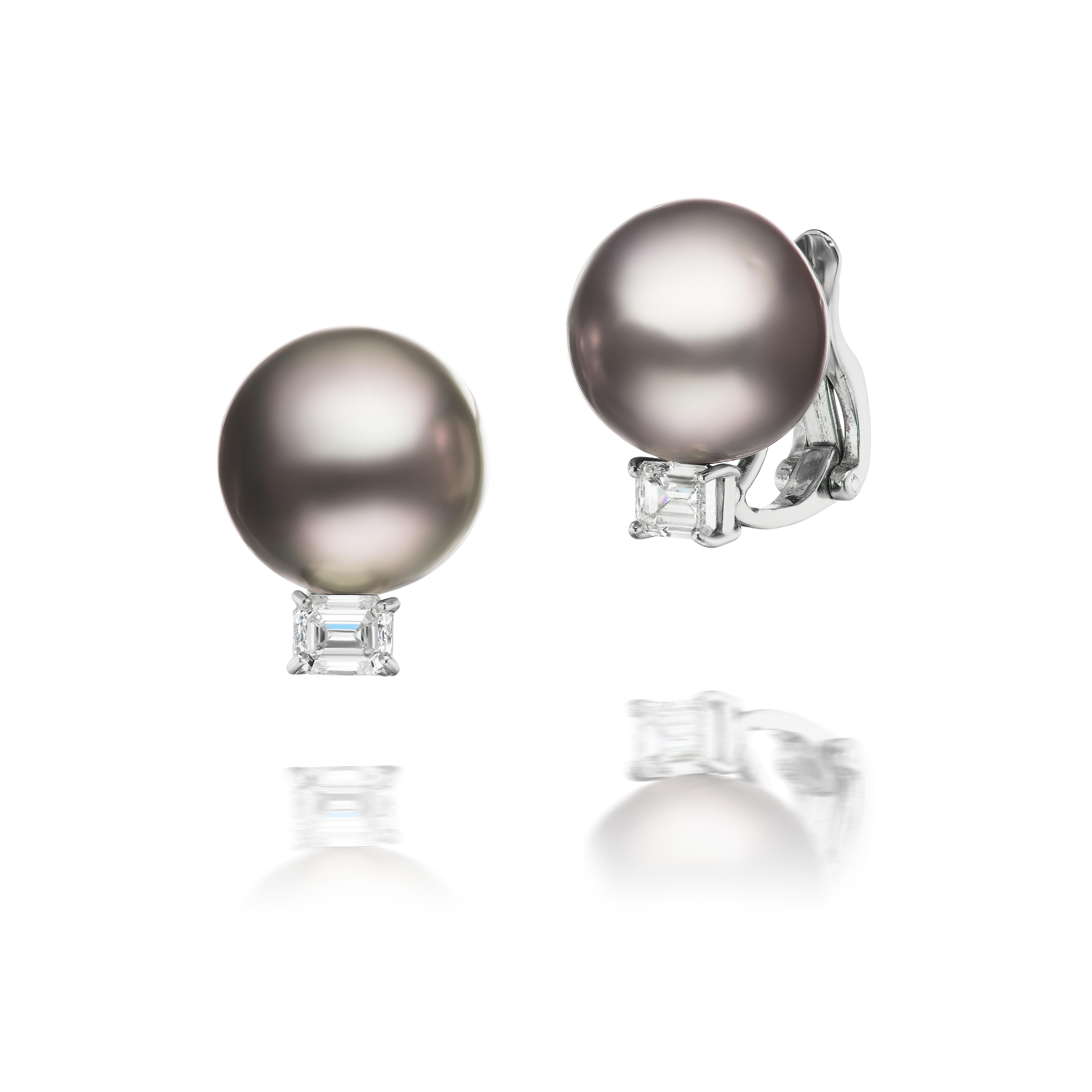 Two lovely 15mm black South Sea pearls are adorned with emerald cut diamonds weighing approximately 1.20 carats total and mounted in platinum.

The diamonds are H/I color and VS clarity