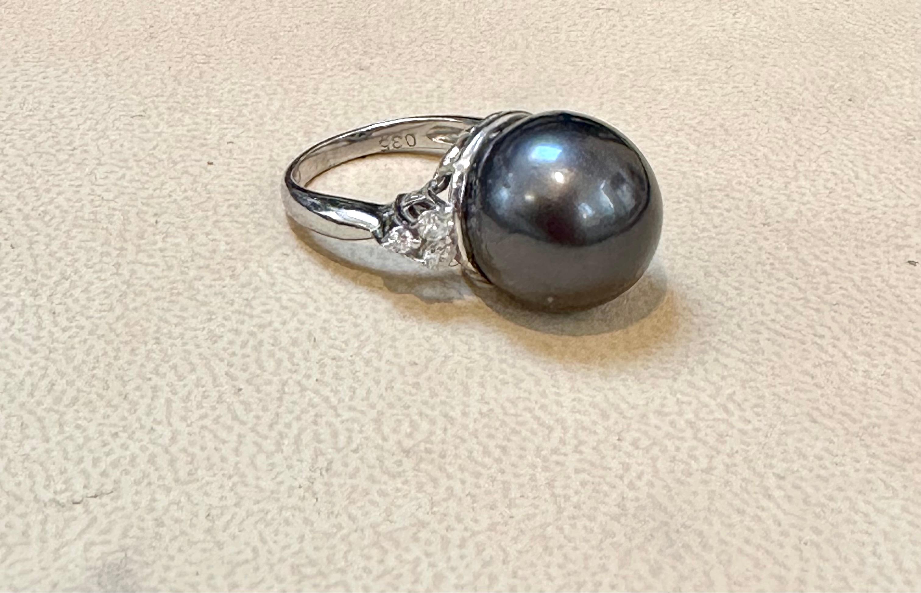 Introducing the exquisite 15mm Round Black Tahitian Pearl & Diamond Platinum Ring, a symbol of timeless elegance. This captivating cocktail ring is meticulously crafted from platinum and features a stunning 15mm Tahitian pearl as its centerpiece.