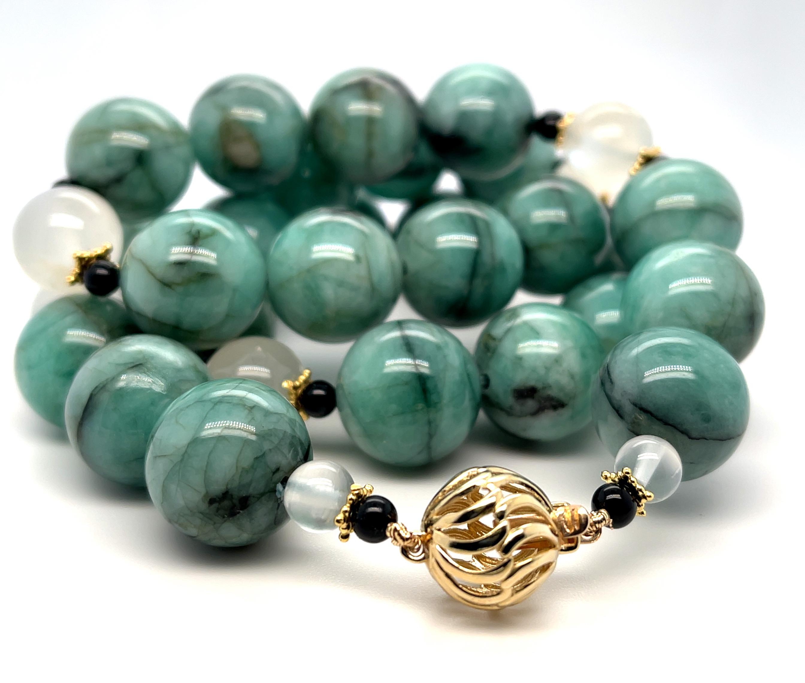 This original strand of natural emerald beads is truly one-of-a-kind! The emeralds in this necklace display lovely shades of soft medium green, variegated with striking black veins that give the beads a luxurious marbled appearance. Arranged with
