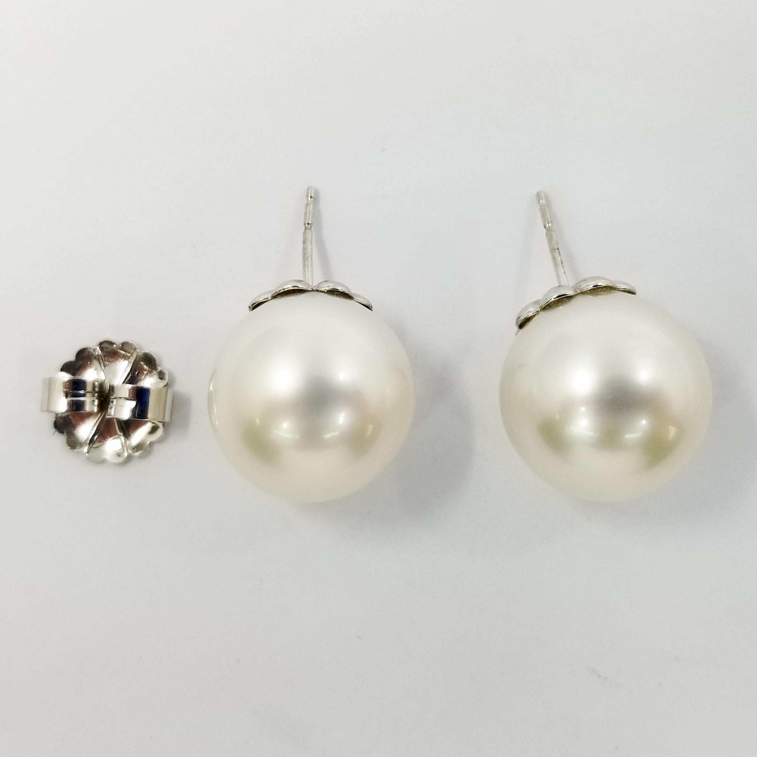 14 Karat White Gold Cultured Pearl Earrings Featuring a Pair of 15mm Round White South Sea Pearls. The Attachment is a Cup with Pierced Post and Large 