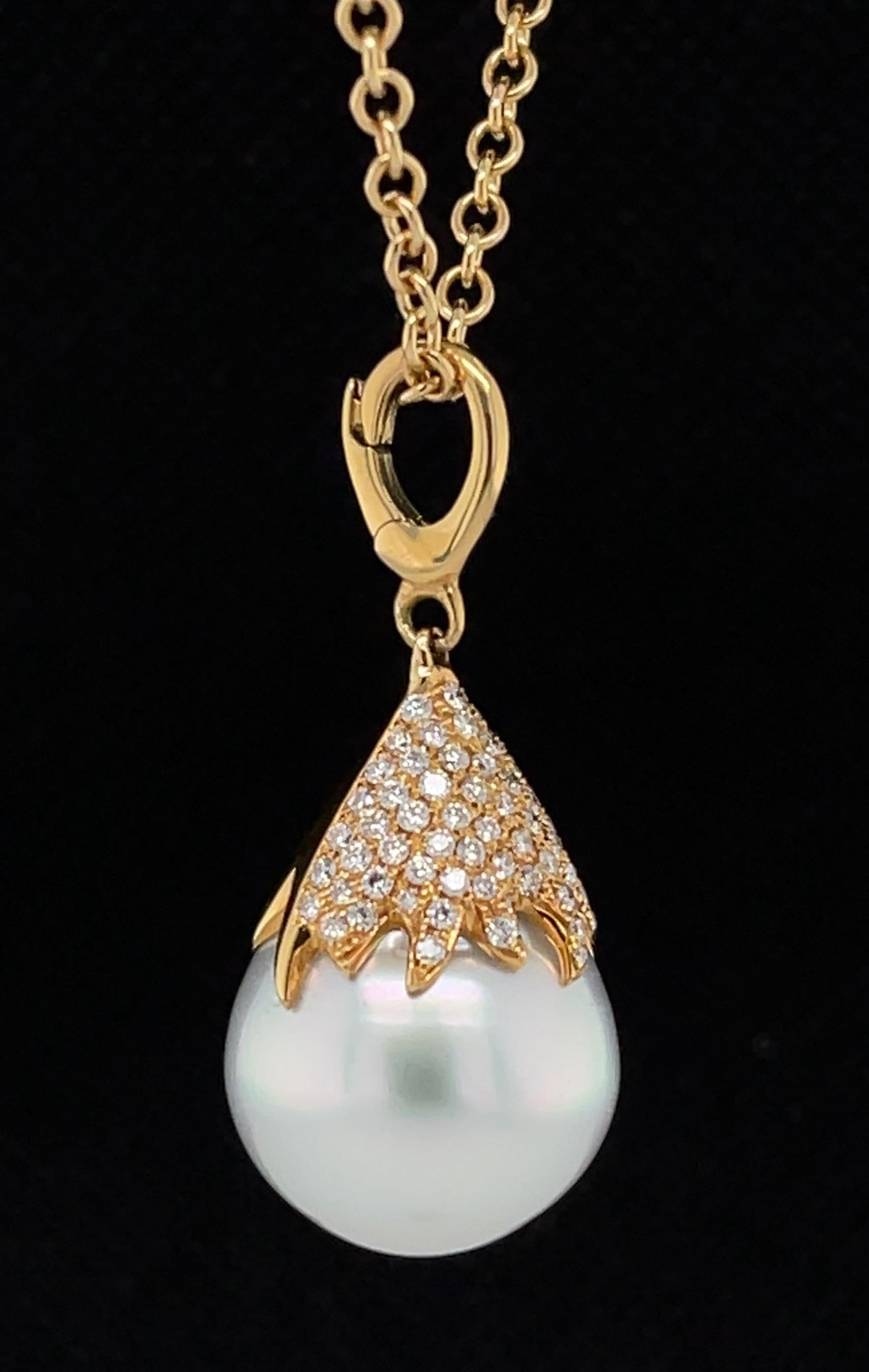 This gorgeous drop pendant features a large, fine-quality white South Sea pearl with beautiful luster! The pearl is topped with a diamond-studded 18 karat yellow gold cap that has been pave set with .63 carat in  diamonds. This is a stunning and