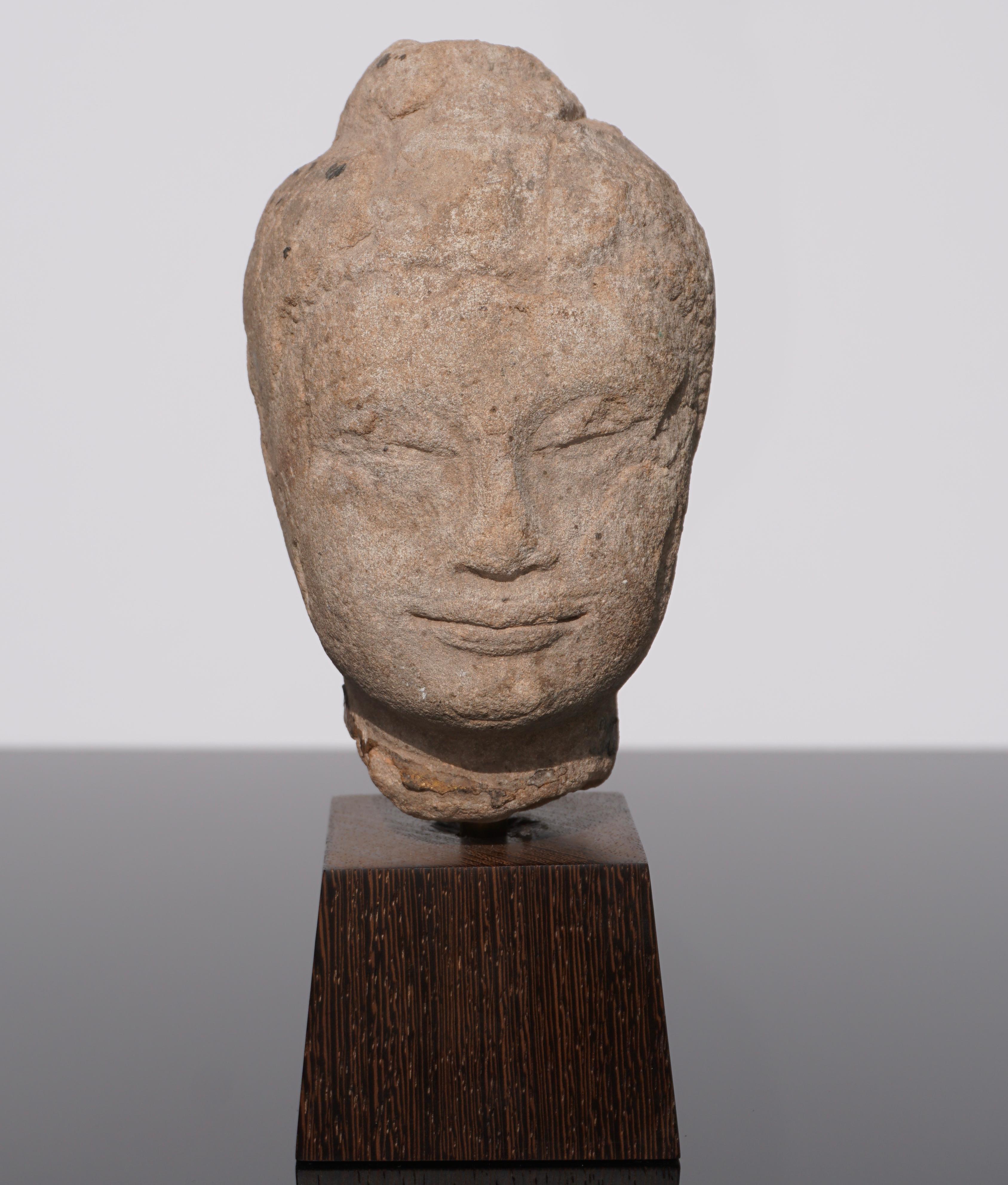 A very serene and calming weathered sandstone Buddha head from Thailand circa 16th century or earlier. Traces of thick gold gilding on neck. I love the feeling this Buddha sculpture figure evokes!

Head: 6 x 4 x 3.75 inches
With Stand: 8.25