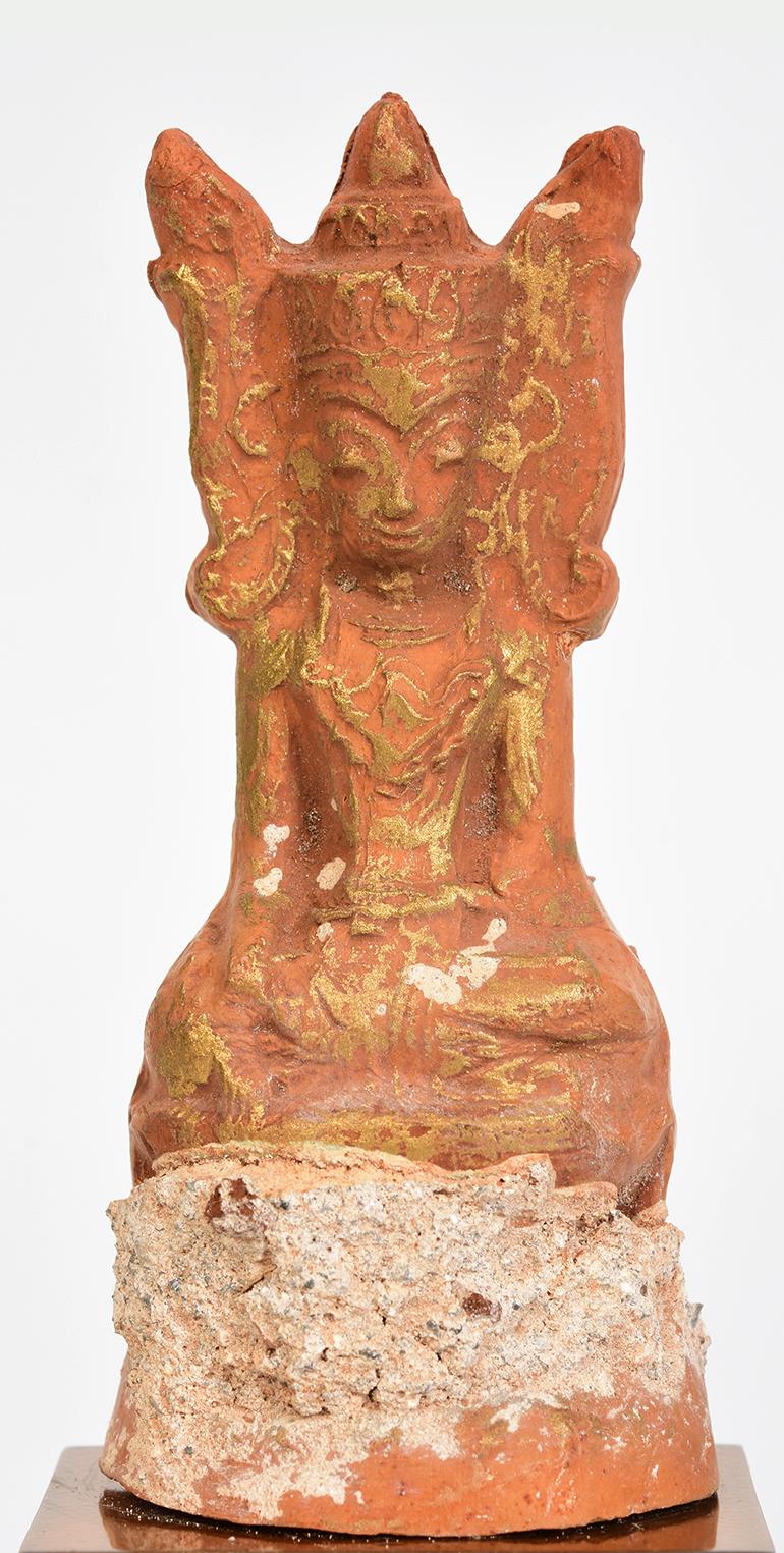 Burmese pottery seated crowned Buddha.

Age: Burma, Ava Period, 15th Century
Size: Height 10.8 C.M. / Width 5 C.M.
Size including stand: Height 16.2 C.M.
Condition: Nice condition overall (some expected degradation due to its age).

100%