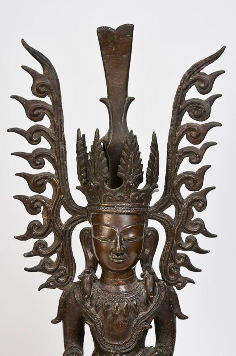 Burmese bronze seated crowned Buddha, or sometimes known as 'King Buddha', wearing diadem-crowns and ornaments of kings instead of ordinary monk's robes. 

Age: Age: Burma, Ava Period, 15th Century
Size: Height 51.4 C.M. / Width 20.2 C.M.
Condition: