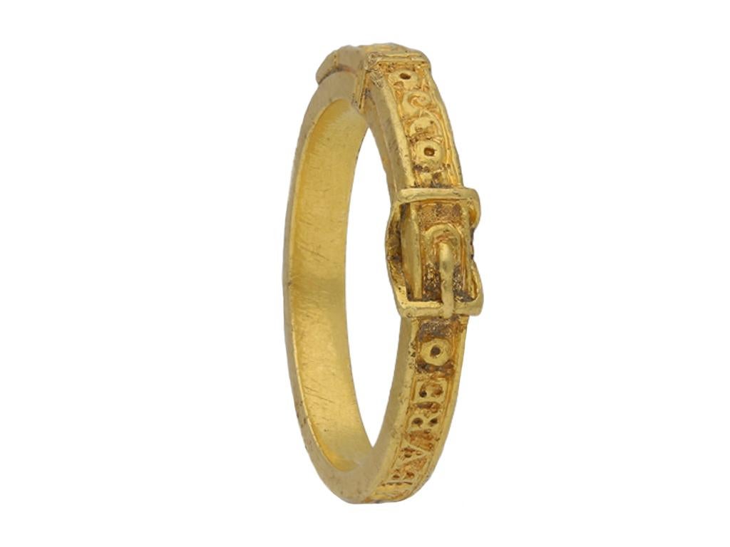 15th century engraved gold buckle ring, ‘At this point remains’. A rare flat top ring featuring intricate detailing around the full circumference with a raised inscription, ‘A\. CE+POINCT+DEMEVRE’ and scrolling motifs, to an overlapping strap design