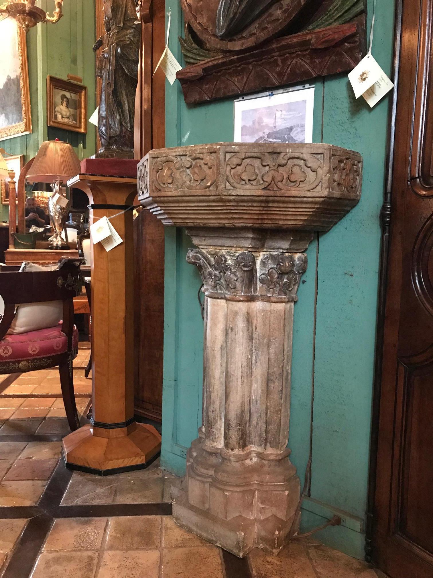 15th Century Gothic Hand carved stone trough basin Benitier on a nicely carved Pedestal wall applique  with a very nice textured surface with the original polychrome colors . 
This gothic Sculpted piece reflects the skill and vitality once achieved