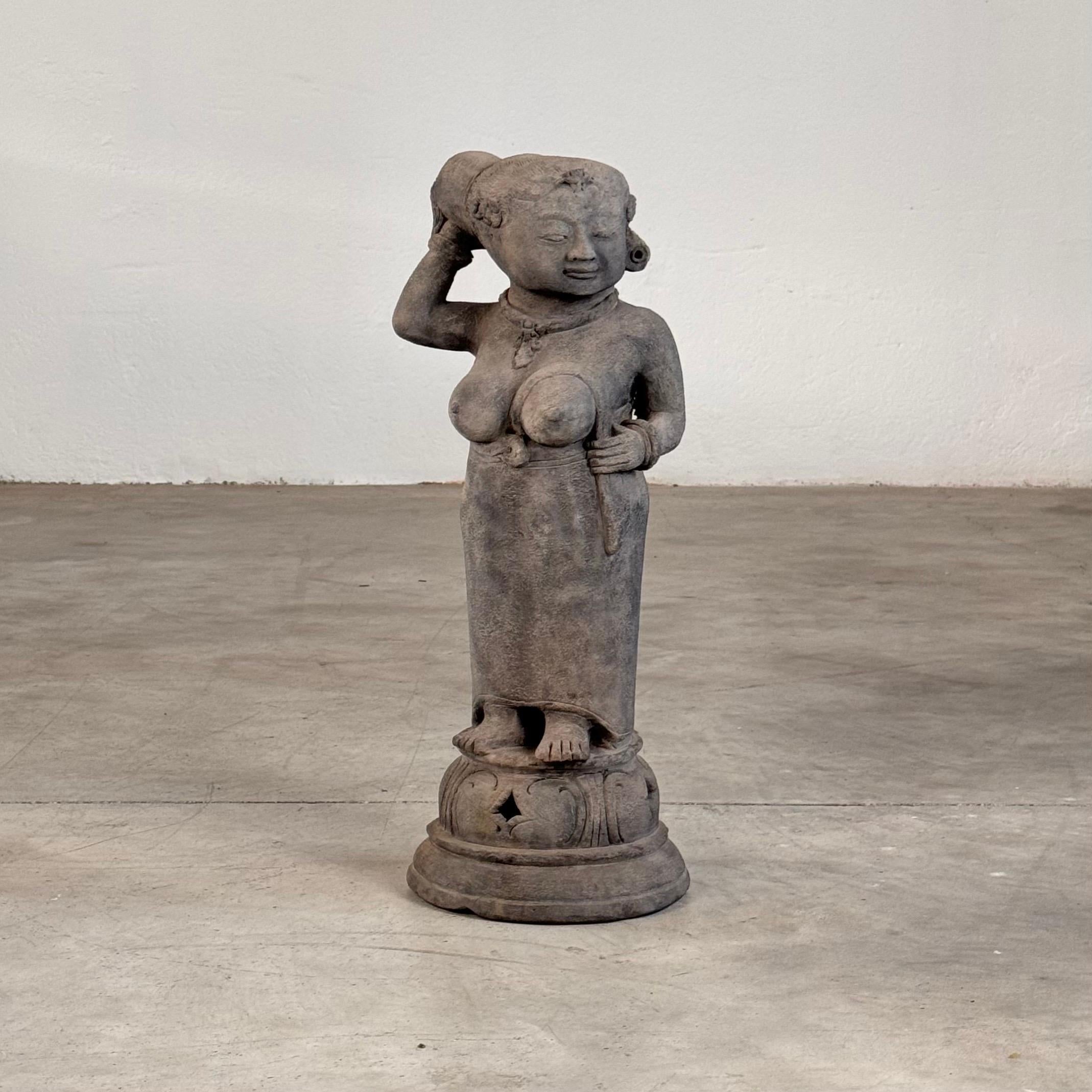 The sculpture captures a moment of serene grace, as the woman delicately holds her hair with her right hand, exuding an air of elegance rarely found in similar works. What makes this piece particularly unique is its unusual coloration: unlike most