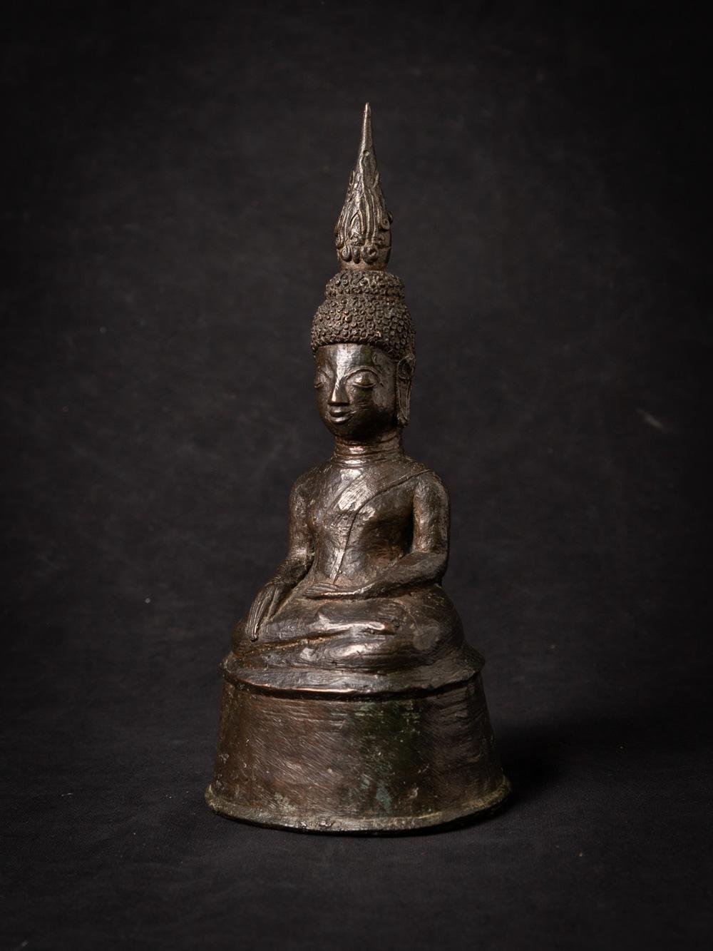 The antique bronze Buddha statue from Laos is a captivating and historically significant artifact that offers a glimpse into the spiritual and artistic traditions of the region. Crafted from bronze, this statue stands at a height of 23 cm, with