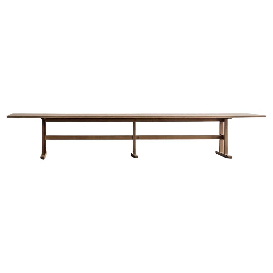 Solid Oak Belgian dining table featuring a modern design, clean shapes and a sculptural base. This traditional Belgian table is handmade from long-lasting french oak. A table to grow old with and share stories around. It stands the passing of time