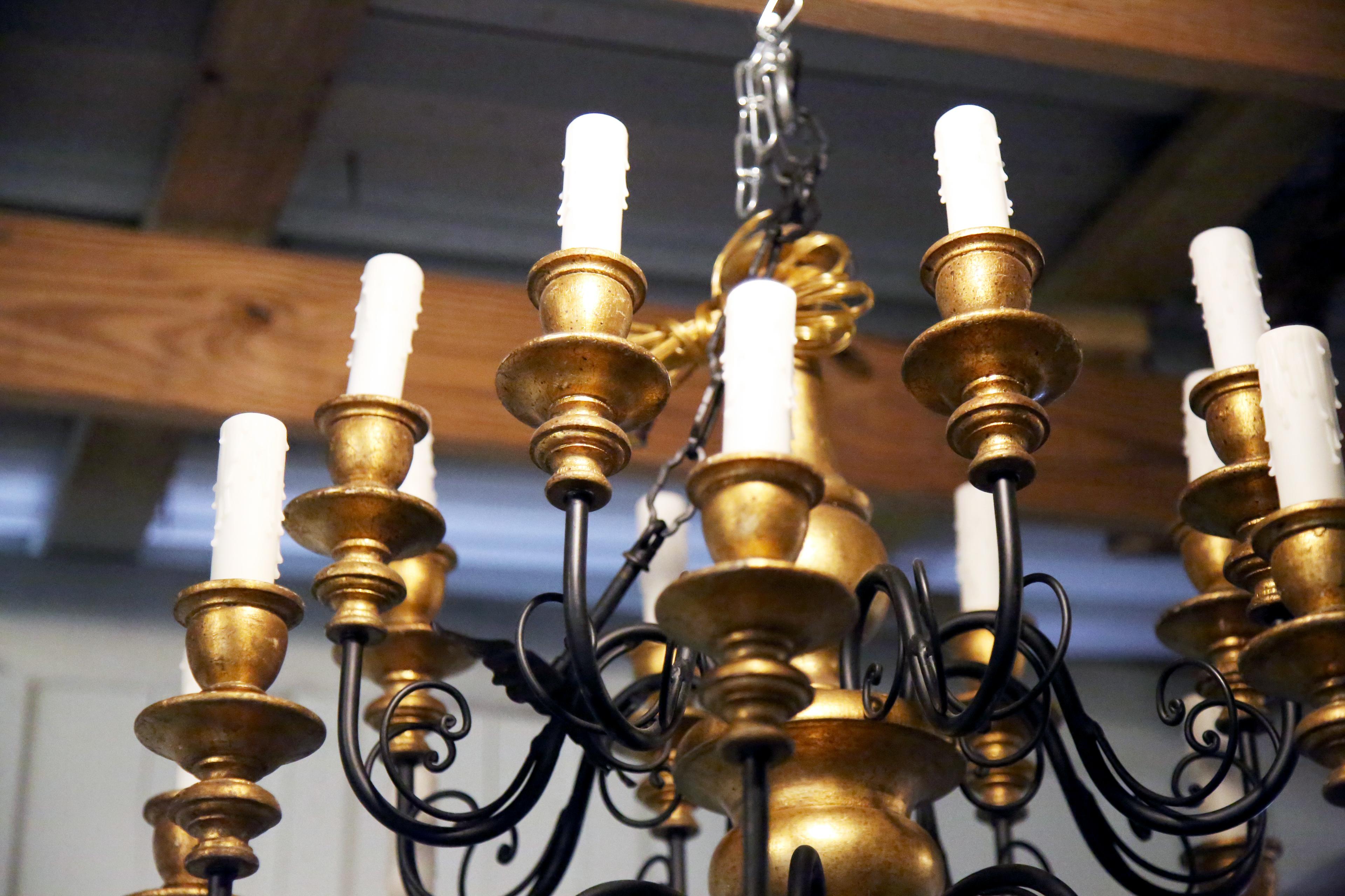 Beautiful 16 arm Italian chandelier in gold gilt with black painted iron arms. Absolutely gorgeous and is a show stopper. This is a unique chandelier that can go in many different design spaces. Rewired for the US and has had a plug added at the end