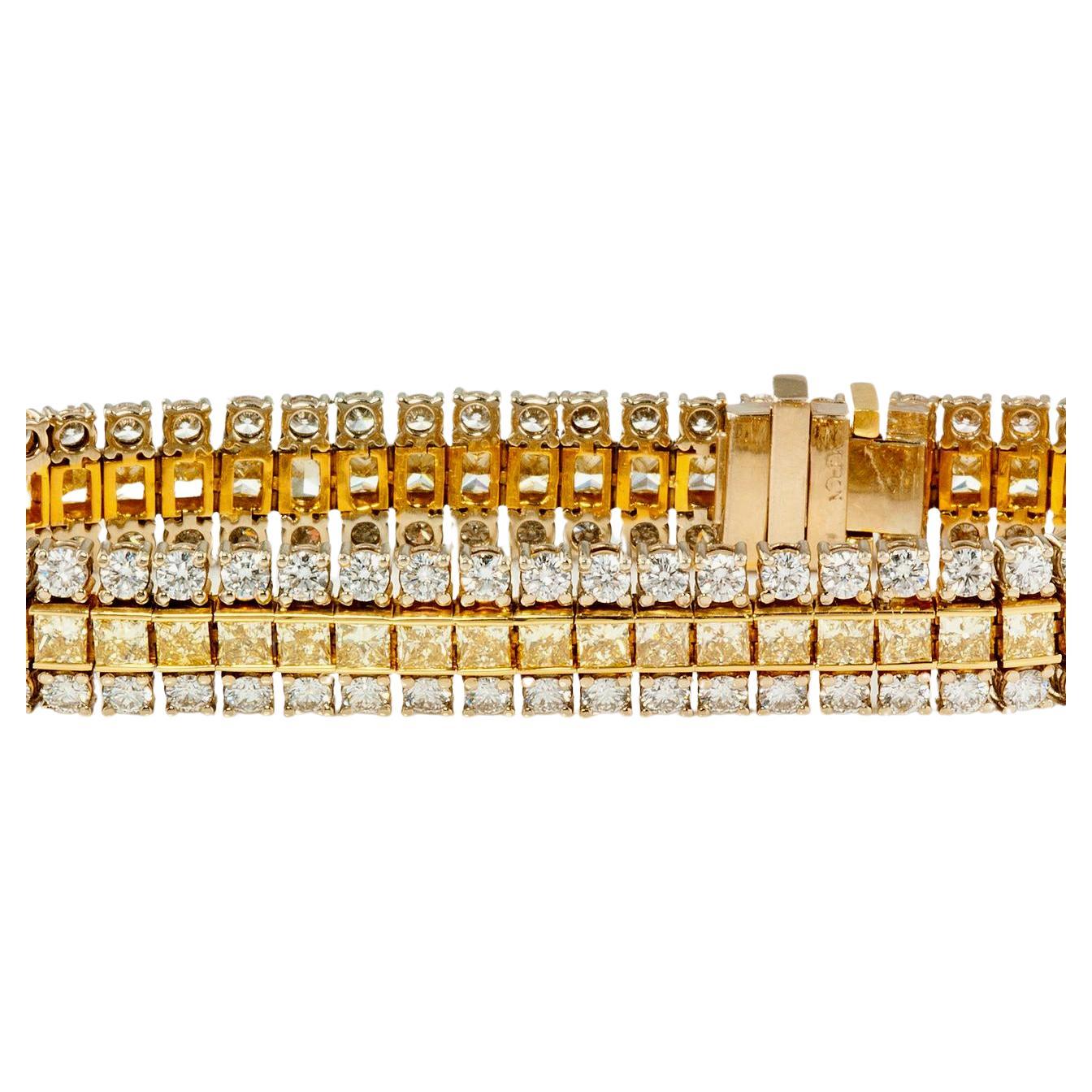 fancy yellow diamond bracelet

16 carat Three Row 18KT Two-tone Diamond Bracelet
One 18KT two-tone diamond bracelet with 8.64ctw of fancy intense yellow princess cut diamonds set in a channel setting center row and 7 ccarat of round brilliant
