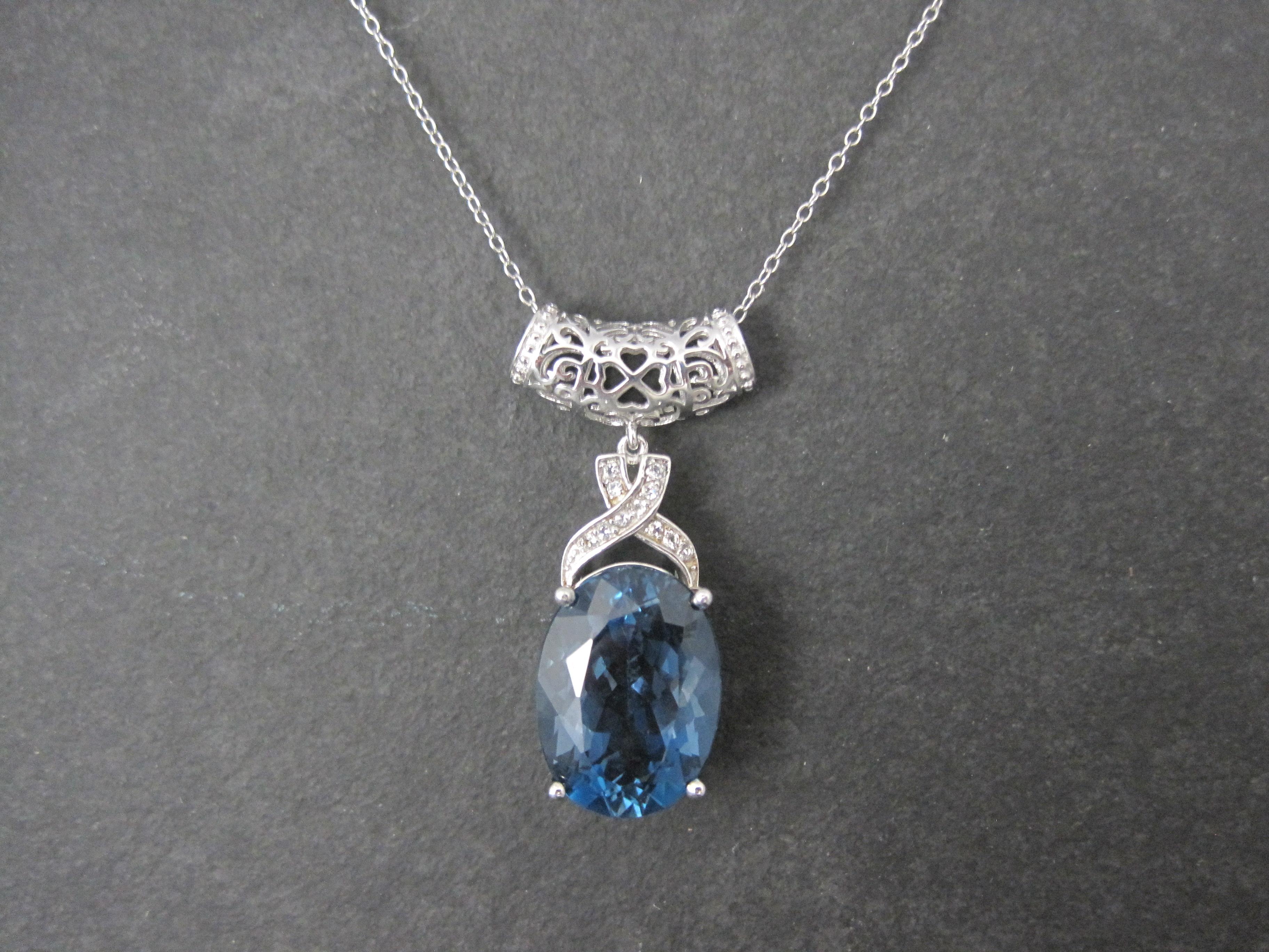 This beautiful pendant is sterling silver. It features a 16 carat, 13x18mm London blue topaz accented by white topaz gemstones.
The pendant measures 3/4 by 1 1/2 inches.
It comes on an 18 inch sterling silver chain.
Excellent condition.