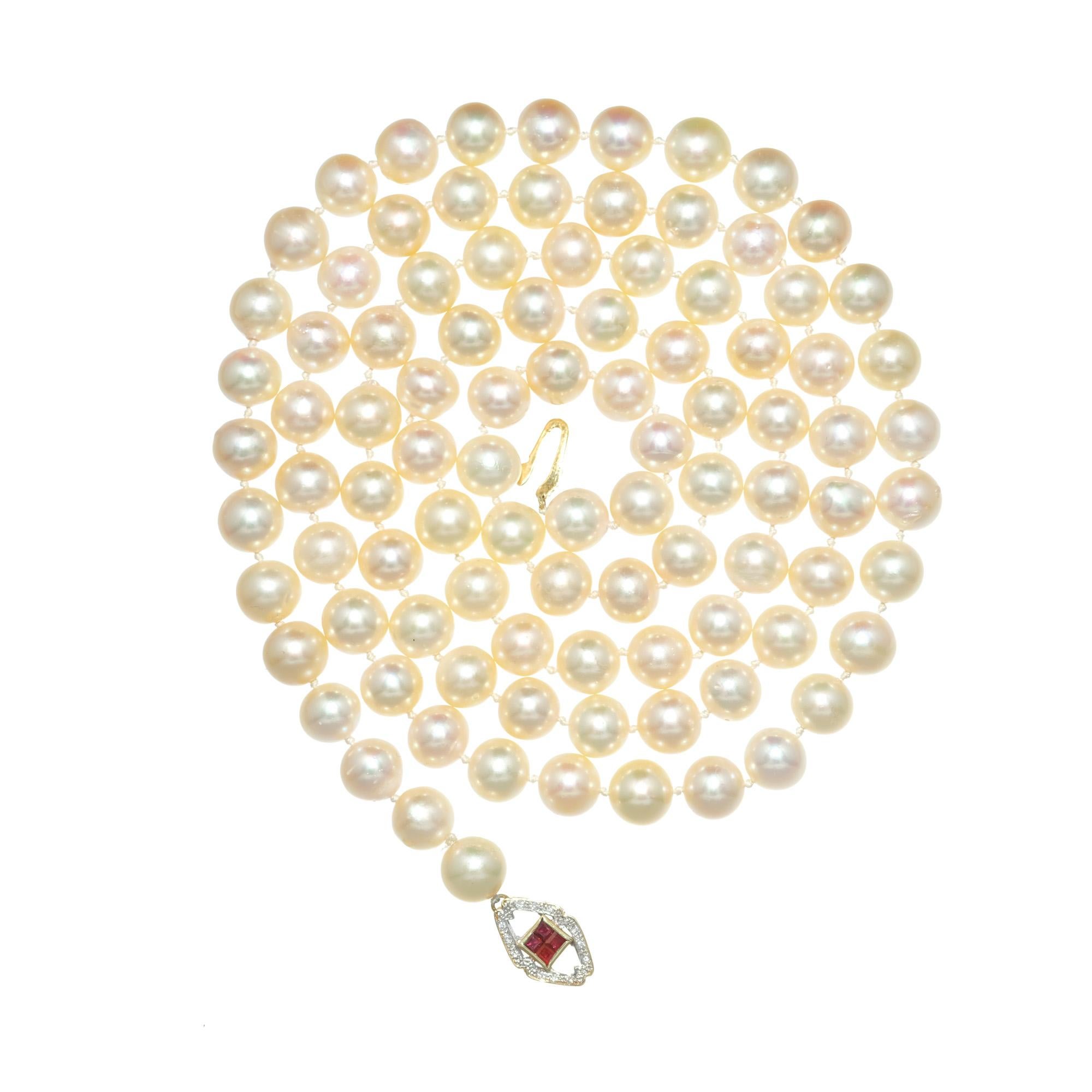 Akoya cultured pearl, ruby and diamond necklace. 34 Inches long 8 ½ to 9mm.  Natural undyed cream color with good lustre. Ruby and diamond 14k yellow gold clasp. Can be worn long or doubled wrapped.  

89 Akoya cultured crème pearls with good