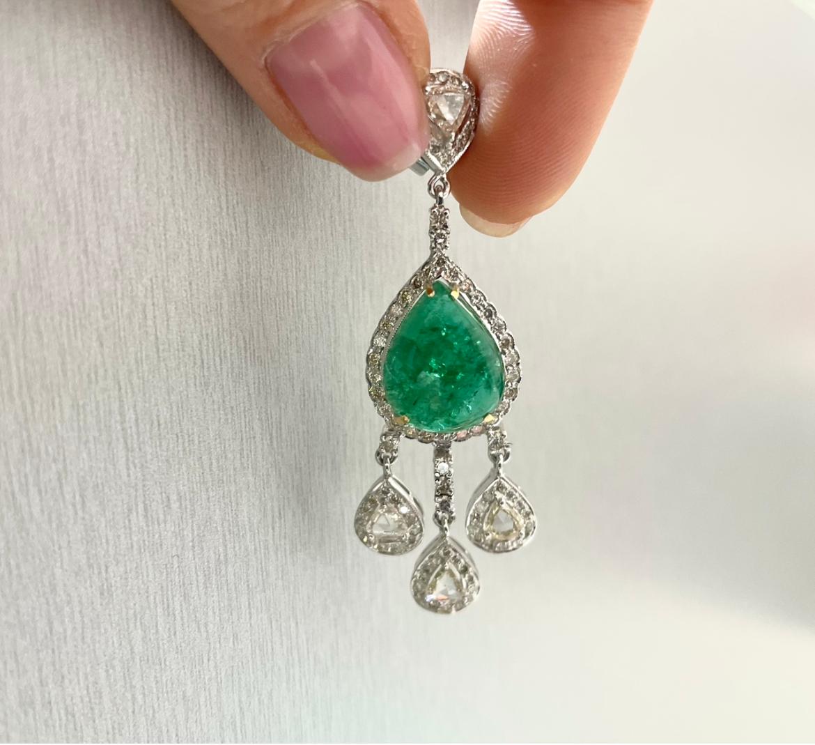 These earrings feature an exquisite design with an emphasis on emerald cabochons and diamonds, all set in 18K gold. The emerald cabochons in these earrings have a total weight of 16 carats, showcasing their captivating green color. Cabochon-cut