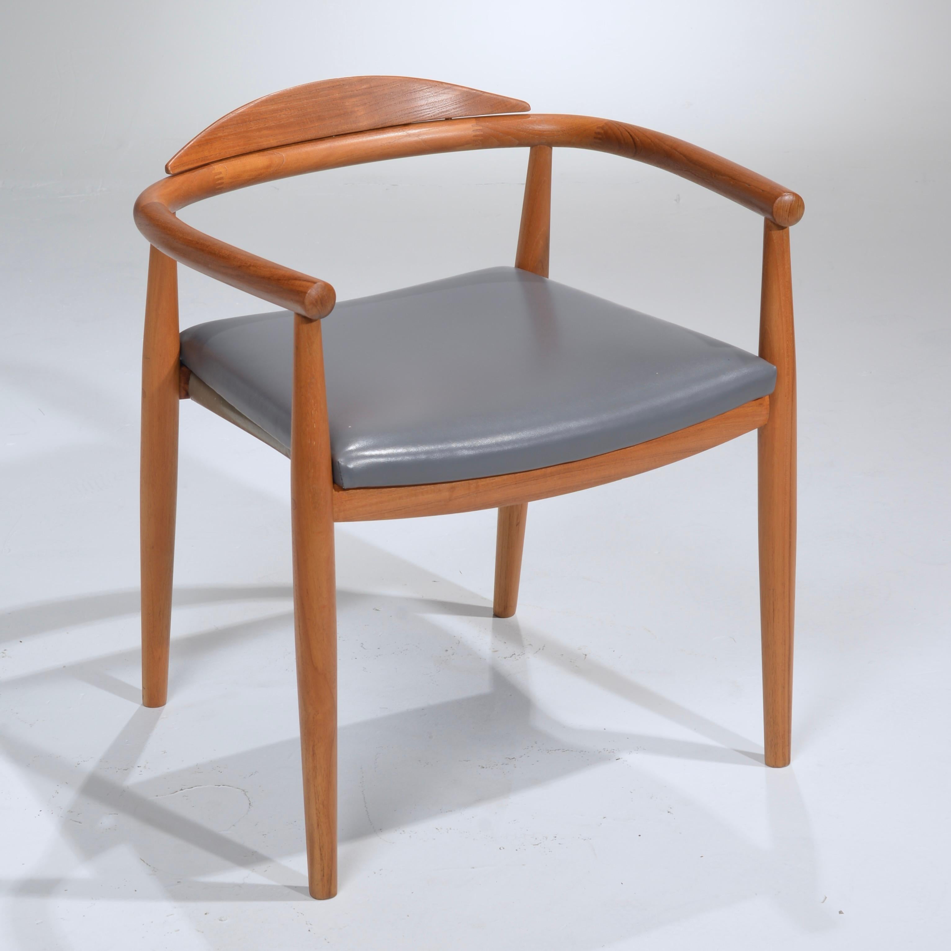 These are great solid teak chairs in the style of Hans Wegner. Made in the USA.
 