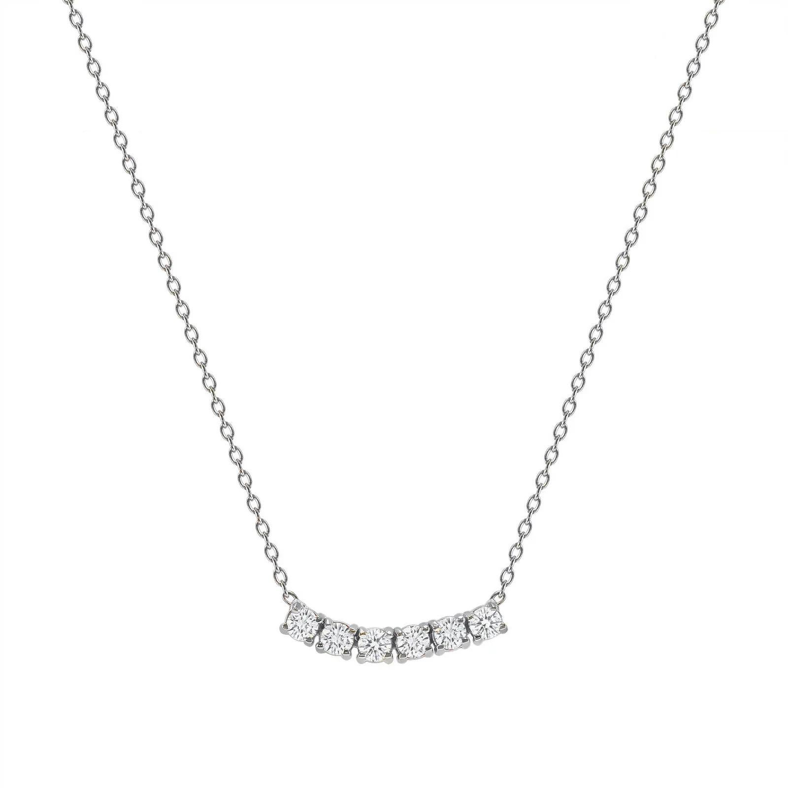 This petite, curved diamond necklace is crafted with gorgeous 14k gold set with six round diamonds.  

Gold: 14k 
Diamond Total Carats: 0.25ct
Diamond Cut: Round (6 diamonds)
Diamond Clarity: VS
Diamond Color: F
Color: White Gold
Necklace Length: 16