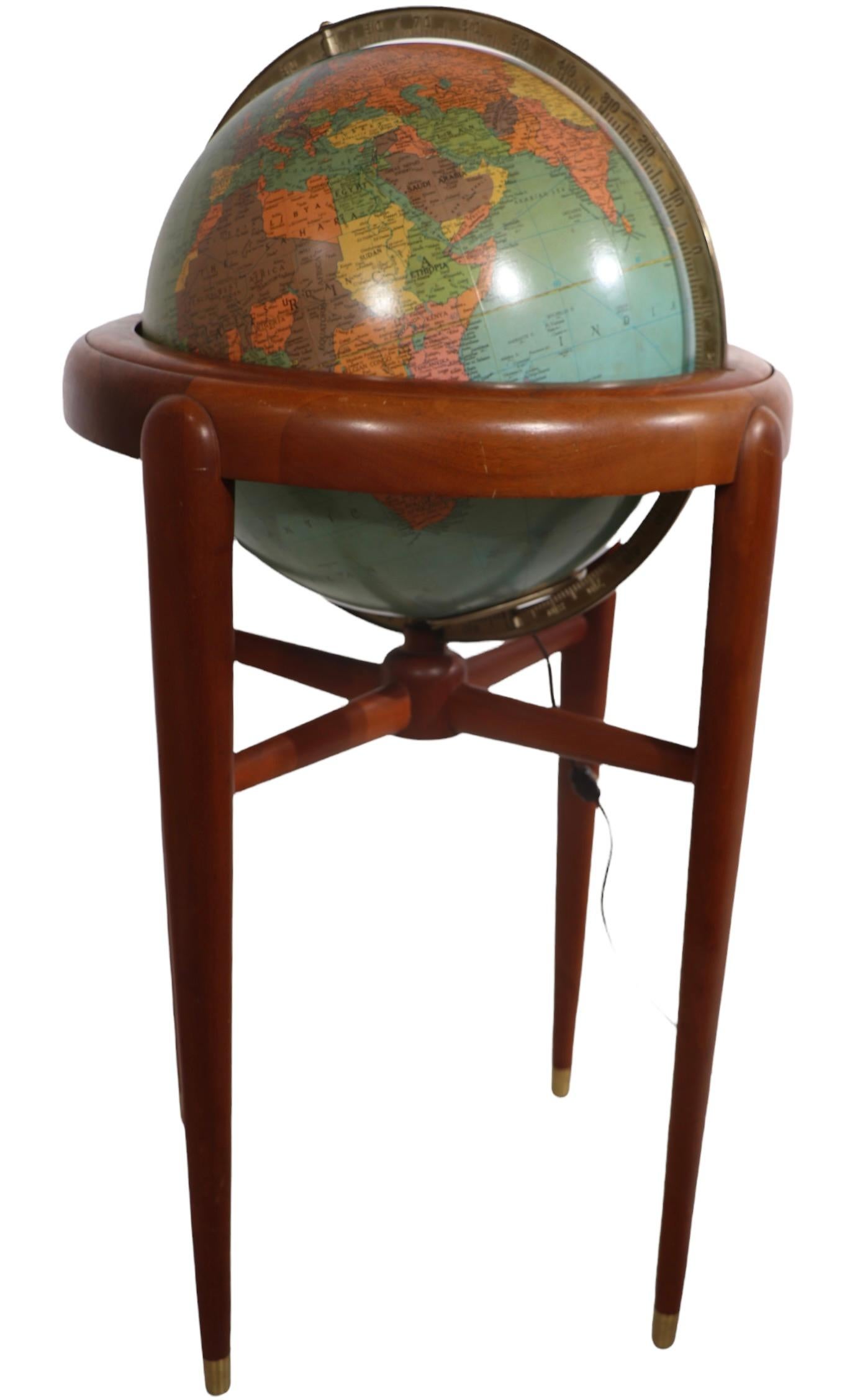 Exceptional light up floor model globe, by Replogle Globes Inc. The globe is 16 in. in diameter, it features an interior light, and restrain a solid mahogany frame. This example is in very good, original, clean and working condition.