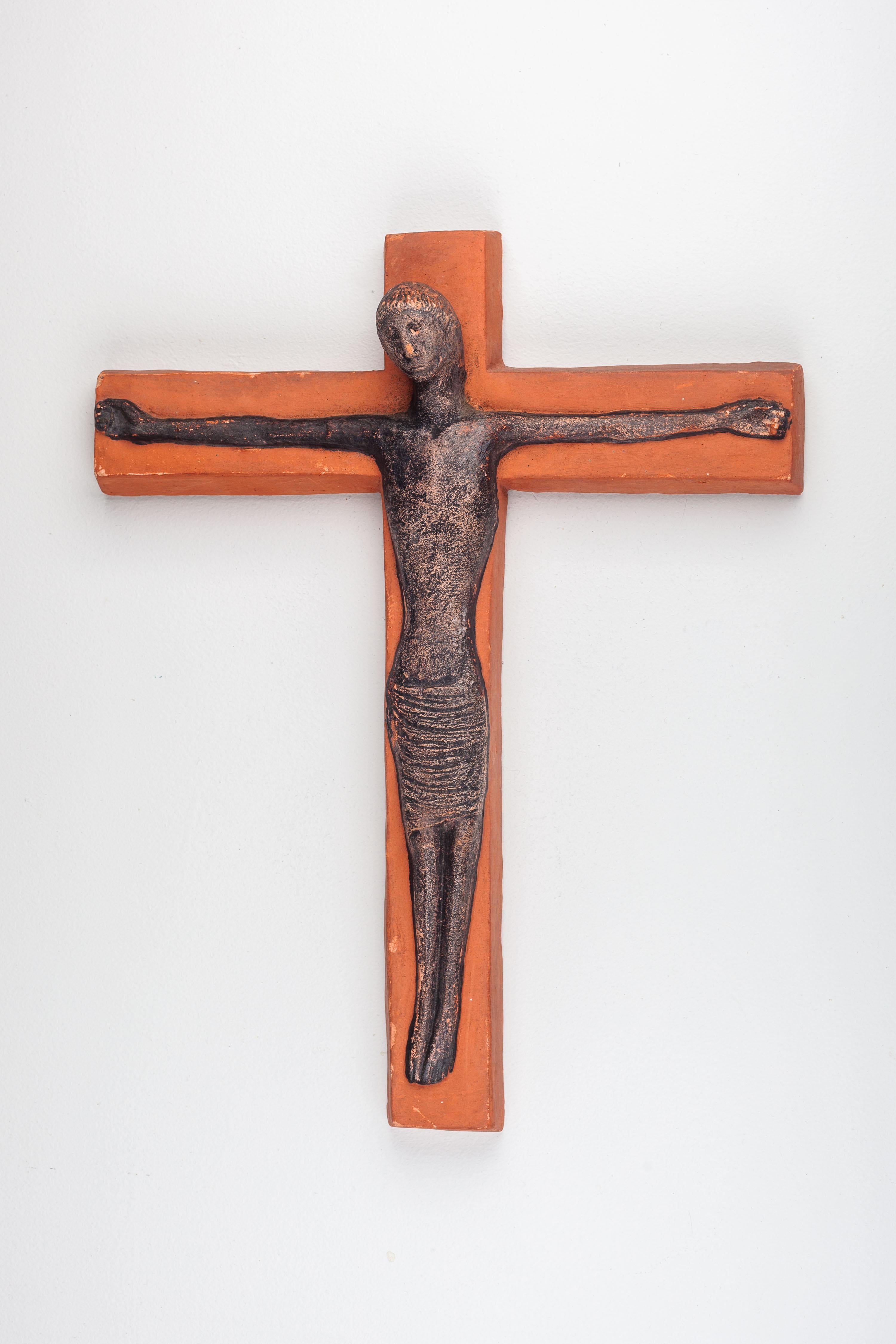 This substantial 16-inch wall cross, crafted in matte terracotta, showcases a black Christ figure with subtle earthy accents. Its impressive proportions and modernist design highlight a compassionate depiction of Christ. The inclined head position