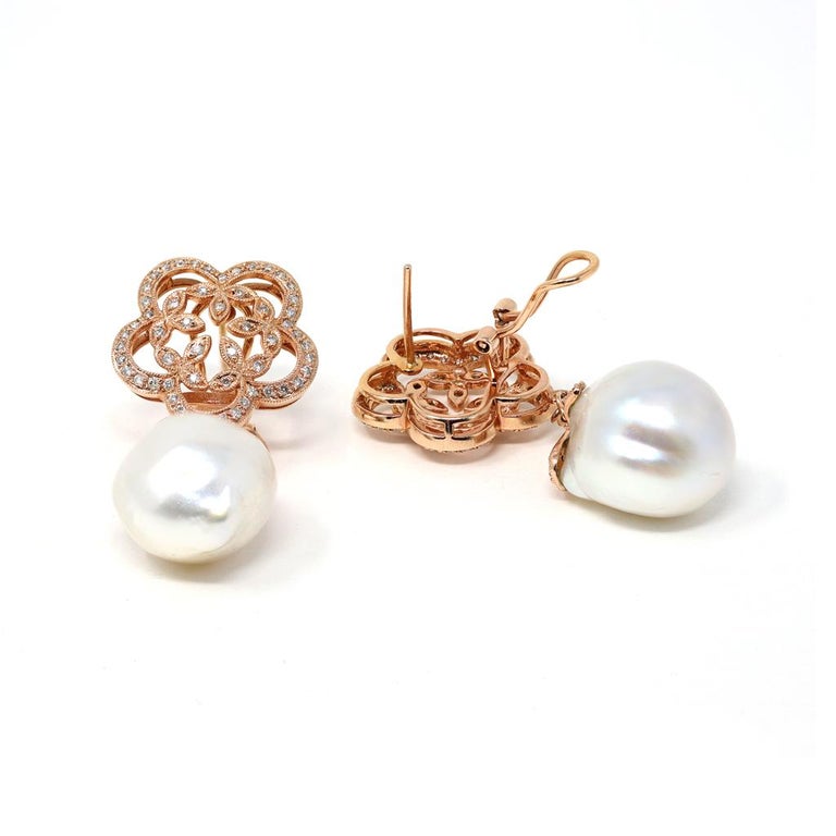 A modern South Sea baroque pearl dangling earrings set in 18 karat rose gold. The bold 16 millimeter free form  pearls display excellent luster and minor surface inclusions. The diamonds have an estimated weight of 0.50 carats; they are GH color and