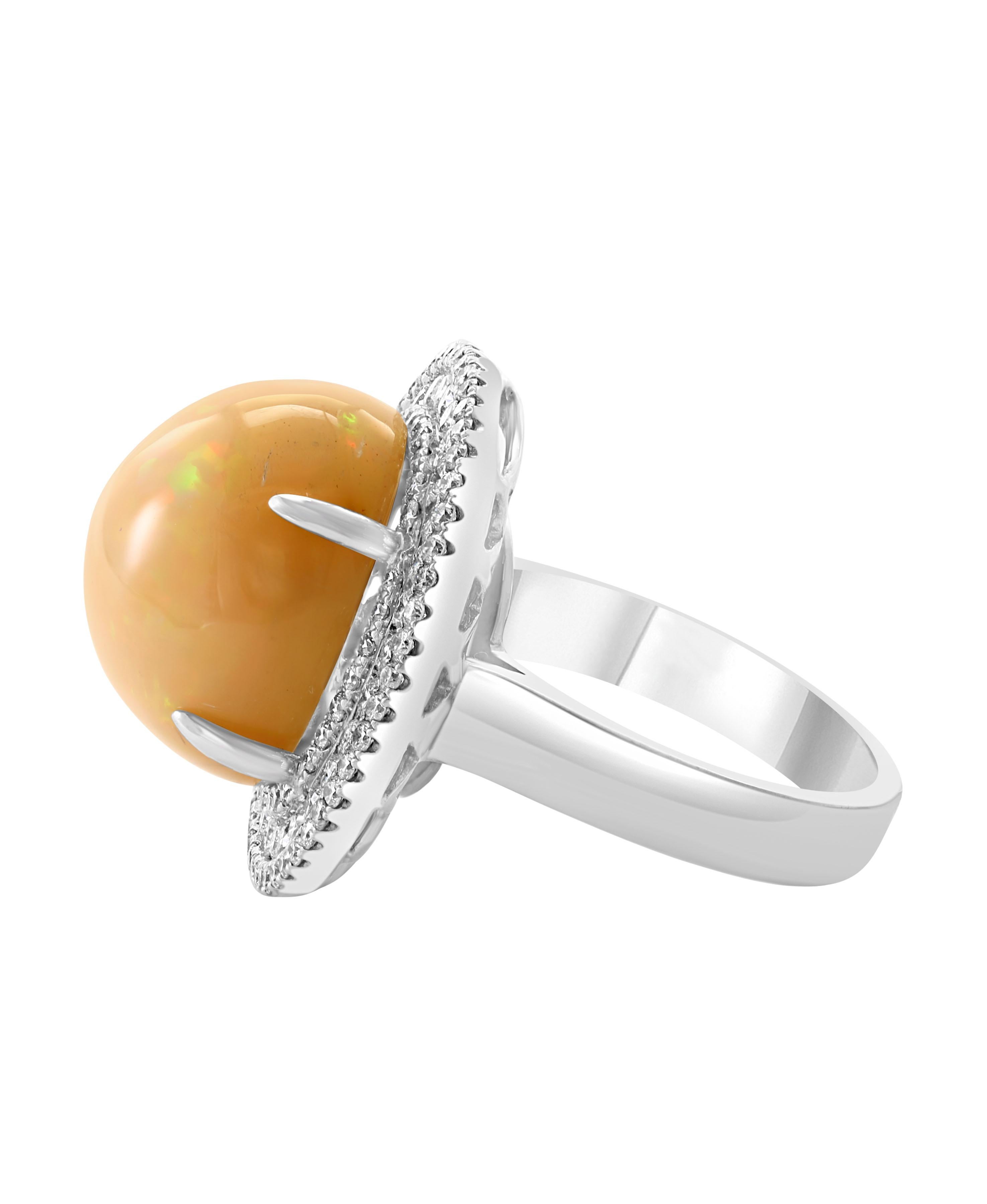 Round Natural Opal  Cocktail Ring   with Diamonds all around the stone 
18 Karat White  Gold Estate
 Approximately 16 mm Round
A classic, Cocktail ring 
Huge Opal very clean no inclusion  in round shape , full of luster and shine  and shades of