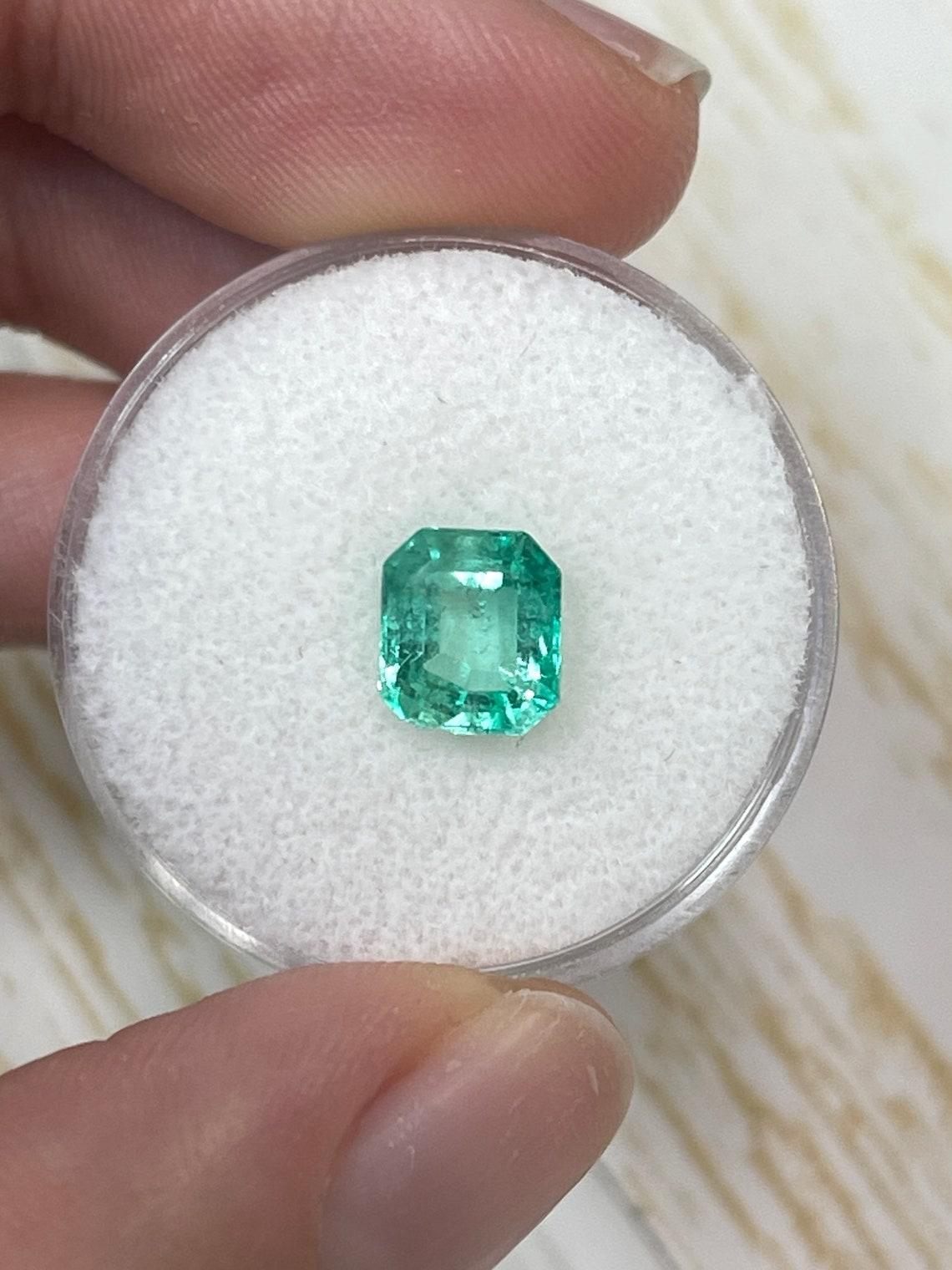Stone: Emerald
Total Weight: 1.60-carat
Shape: Emerald Cut
Clarity: Transparent
Luster: Excellent/Very Good
Color: Pastel Light bluish-green
Measurements: 7.54mm x 6.65mm x 4.57mm
Geographic Origin: Colombia
Treatment: Natural, Oiling

Notes: This