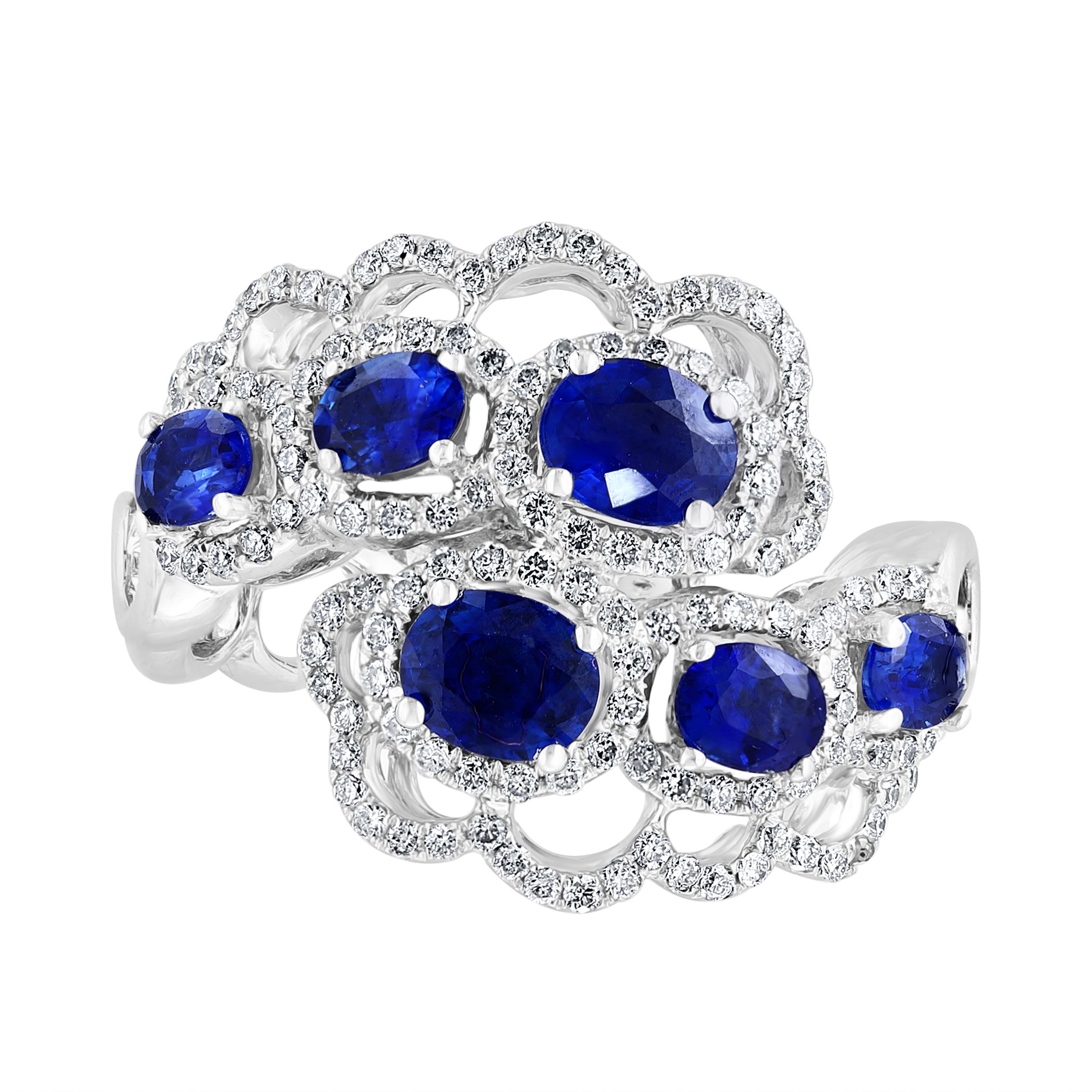 A fashionable and color-rich ring showcasing 6 blue sapphires, each surrounded by a brilliant diamond halo. Set in an openwork design shank. Blue sapphires weigh 1.60 carats total; accent diamonds weigh 0.56 carats total. Made in 18k white gold.