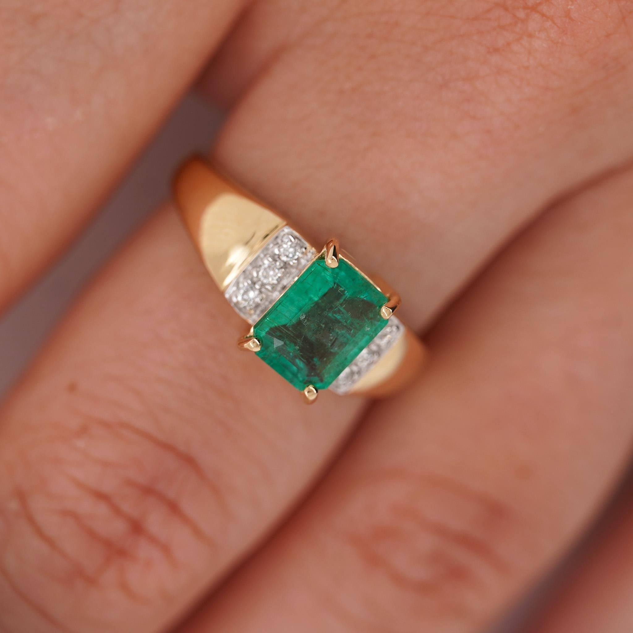 This bold cocktail ring features a 1.60 carat emerald in a classic four-prong setting with six accent diamonds on each shoulder. Made of 14K yellow gold, the piece is substantial with a polished finish and 4.3mm average band width.

Details:
Item