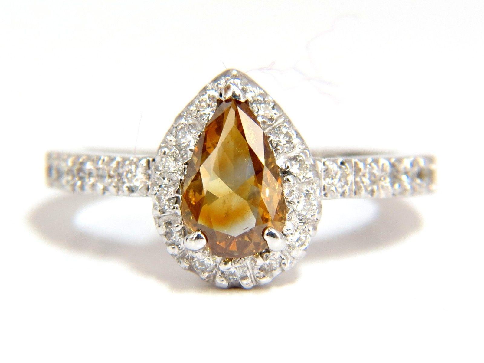 Sparkling Golden Yellow Browns Flash Fancy color Pear cut Diamond ring.

Natural Fancy color Center diamond: 1.10ct. 

Pear shape

5.2 X 7.9 mm

Si-1 clarity



.60ct. Side rounds diamonds:

G-color Vs-2 clarity.

14kt. white gold

4.4