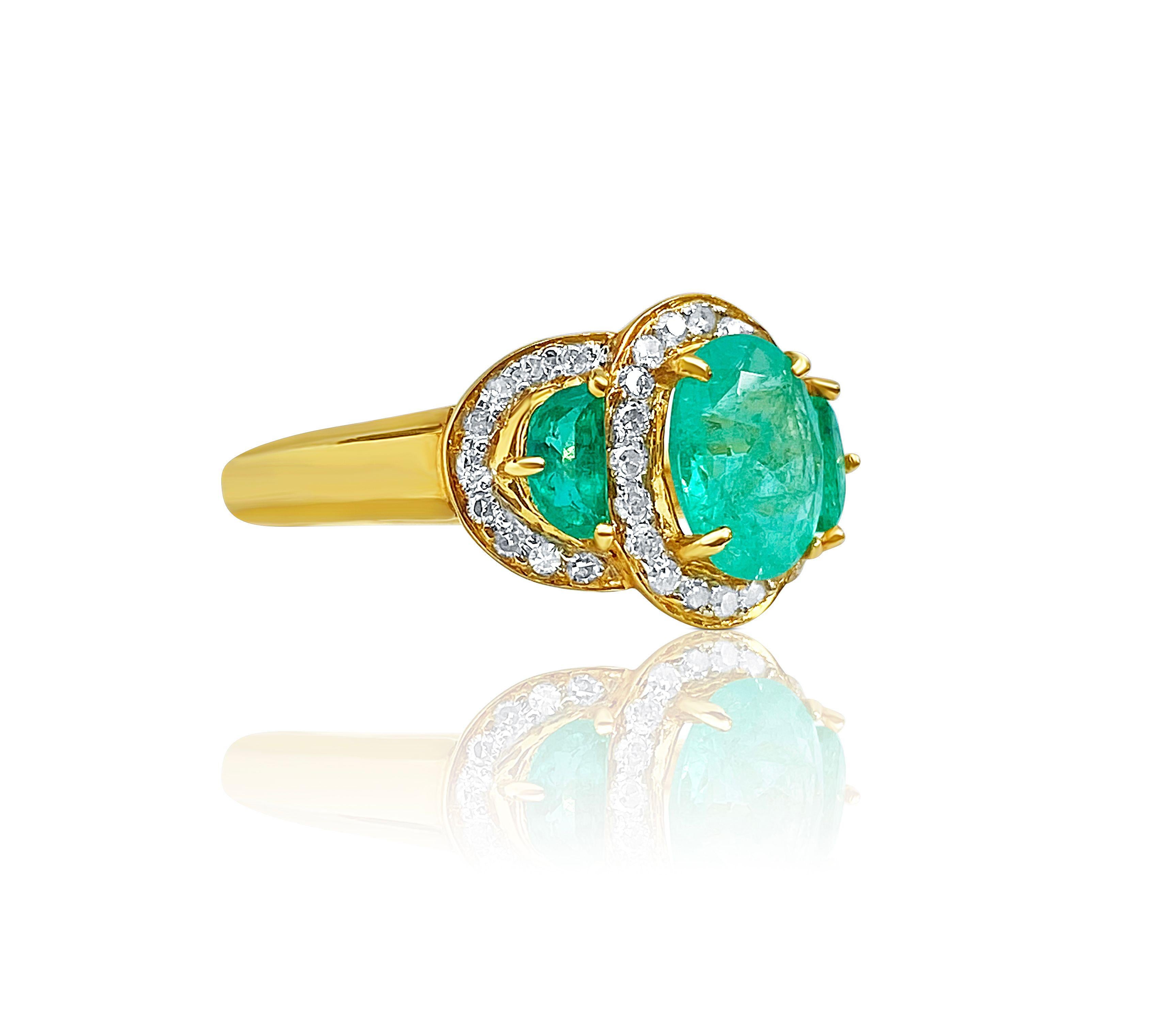 Centering a 1.10 Carat Oval-Cut Colombian Emerald, flanked by two 0.25 Carat Half-Moon Cut Colombian Emeralds, accented by another 38 Round-Brilliant Cut White Diamonds, and set in vivid 18K Yellow Gold, this classic Emerald suite is ideal for the