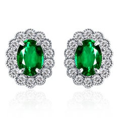 1.60 Carat Oval Emerald Stud Earring with 0.50 ct Diamond Halo in 18W ref449
