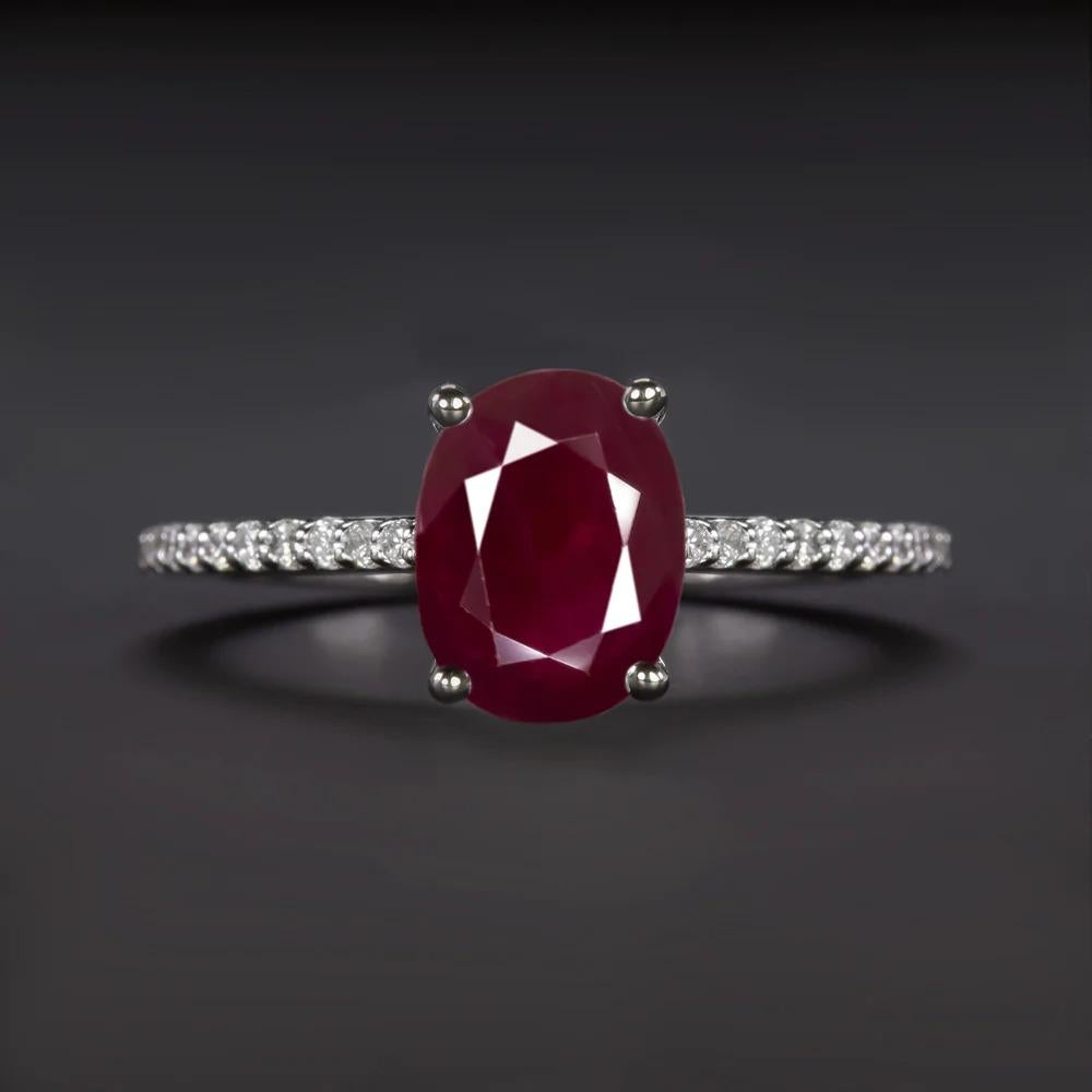 stunning ruby and diamond ring features a rich red 1.60 carat ruby accented by bright white diamonds. The ruby’s red hue is absolutely fantastic, and stands out strikingly against the diamonds and white gold. The slender, diamond accented band