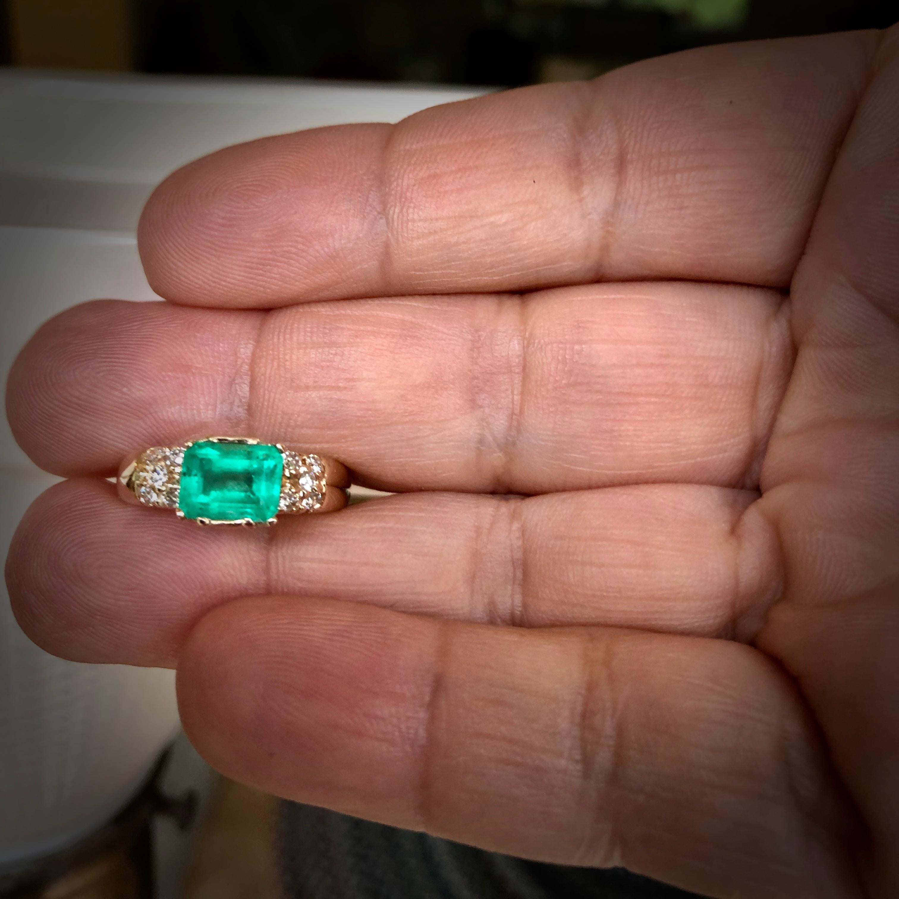 Natural Colombian emerald emerald cut vintage solitaire ring 14K yellow gold with diamond accents.
Emerald approx. weight 1.40 carats, the emerald measurements are 7.69x5.83x4.35mm. Natural Medium Green, VS clarity. Accents round brilliant cut