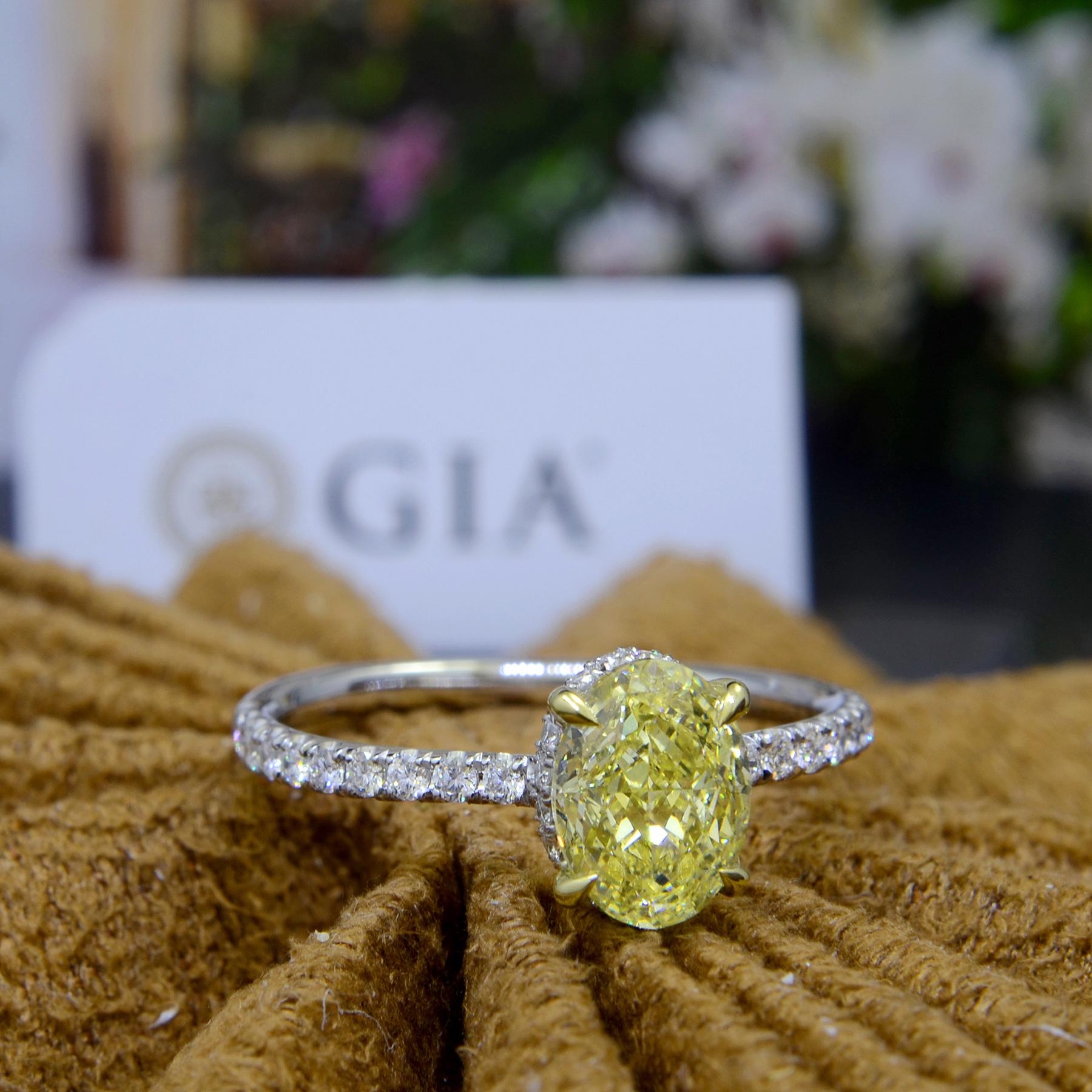 This lovely canary diamond engagement ring features a 1.00 Ct. natural fancy yellow oval cut diamond with SI1 clarity. Surrounding the center gem and all around the shank are 0.60 Ct. of round cut diamonds in U-Pave setting. 

Ring Details
Metal	: