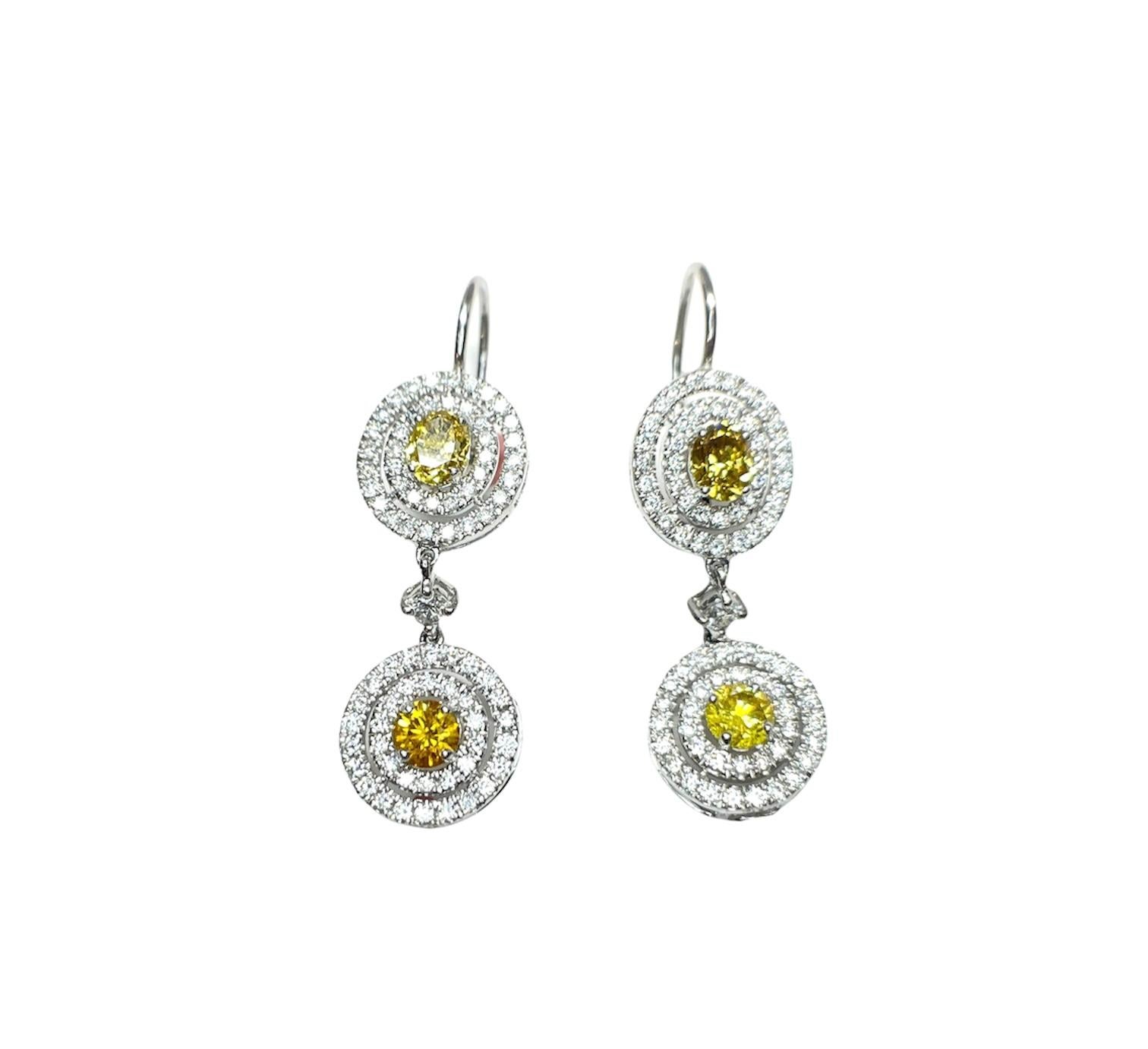 These stunning multi-color diamond earrings feature 4 natural color diamonds GIA certified weighing 1.60cts and 151 diamonds weighing 1.78cts set in platinum.