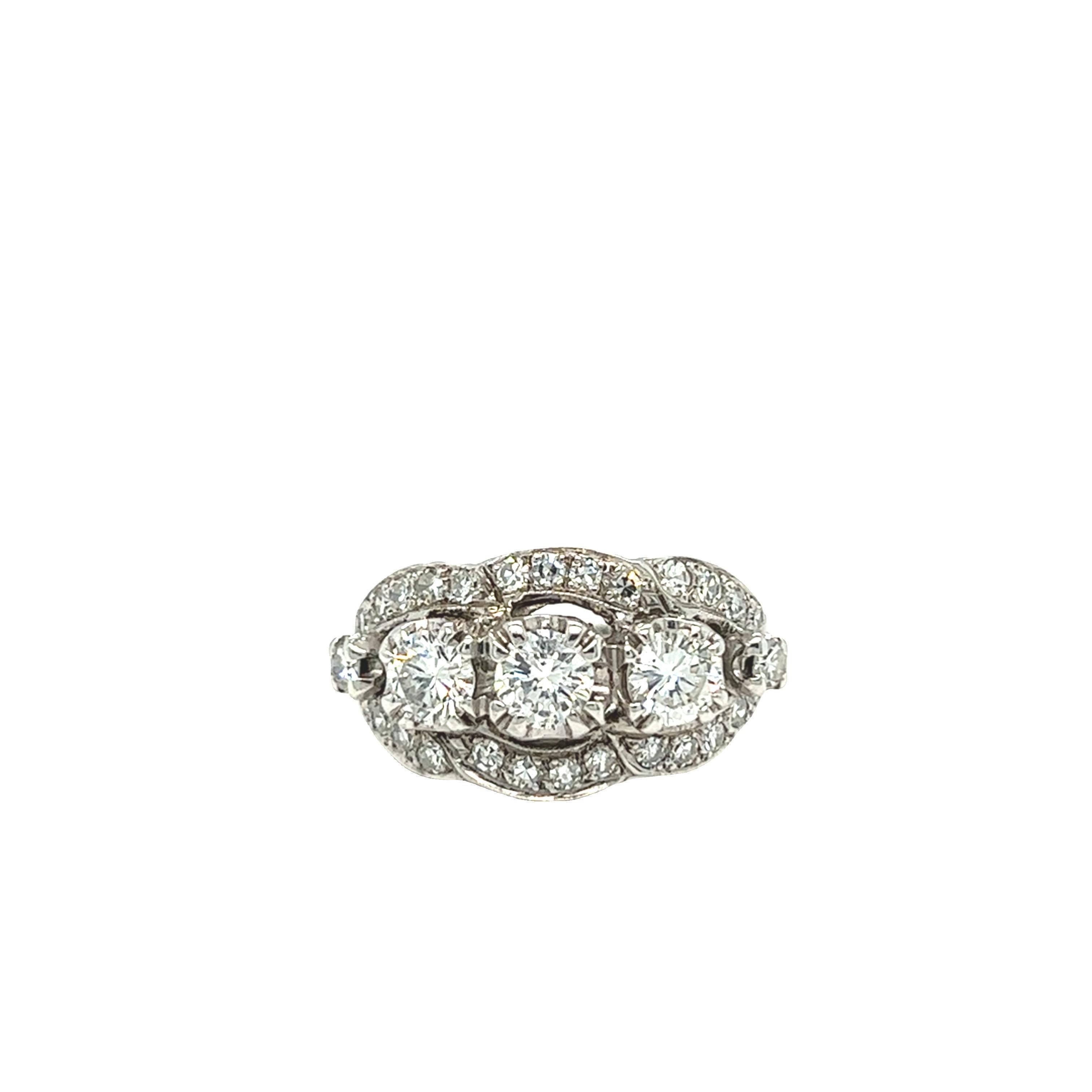 Vintage diamond ring showcases three diamonds at center weighing 0.40 carat, 0.30 carat, and 0.30 carat with quality H color and SI1 clarity. Near colorless single cut diamonds beautifully frame around the center three stones in ribbon like design