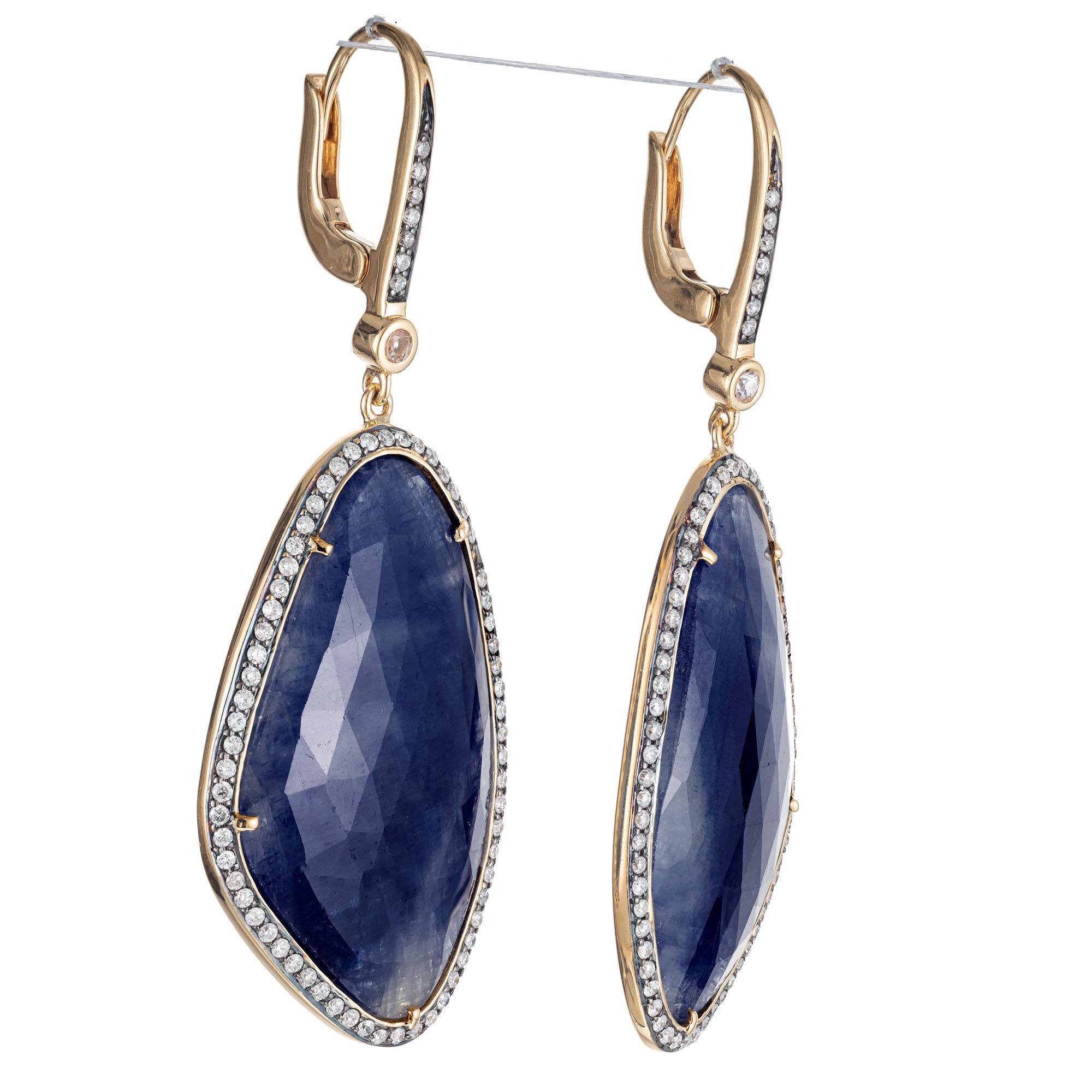  Designer JMP sapphire and diamond dangle earrings. 2 custom cut 16.00ct sapphire slices set in 18k yellow gold with round diamond halos.  

2 custom cut Sapphires, approx. total weight 16.00cts, 31.43 x 17.81 x 4.37mm
144 round diamonds, approx.