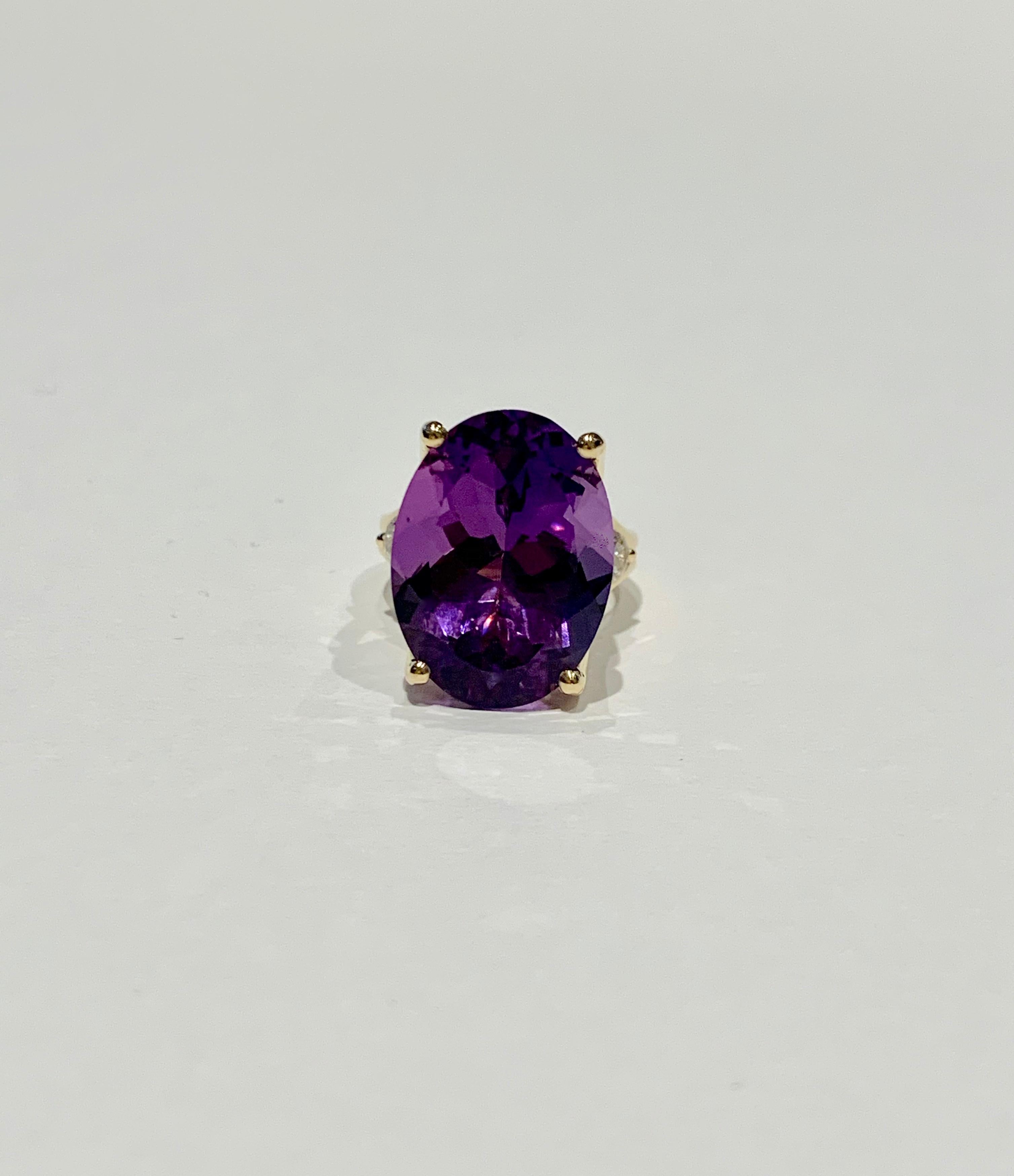 This BESPOKE cocktail ring features a beautiful 16 ct dark purple oval Amethyst* which is the Birthstone for February.  The Amethyst has wonderful transparency and is set in a double band of 18ct Yellow Gold with four claws and two .25ct round