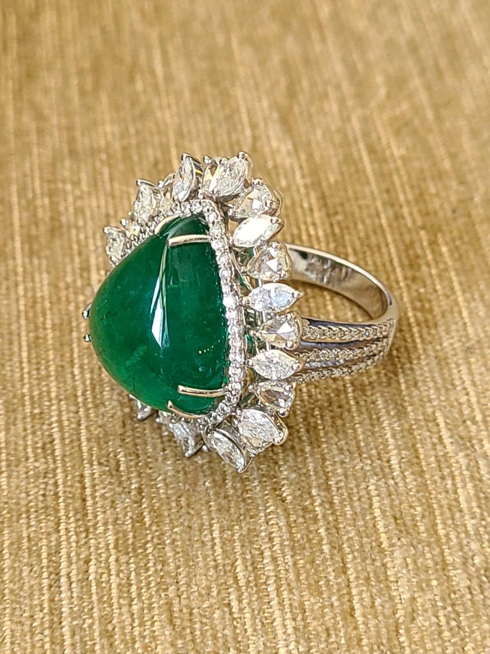 A very beautiful, one of a kind, Zambian Emerald & Diamonds Cocktail Ring/ Pendant set in 18K Gold. The Emerald, trillion shaped, weighs 16.01 carats & is of Zambian origin. The Emerald is completely natural, without any treatment. The combined