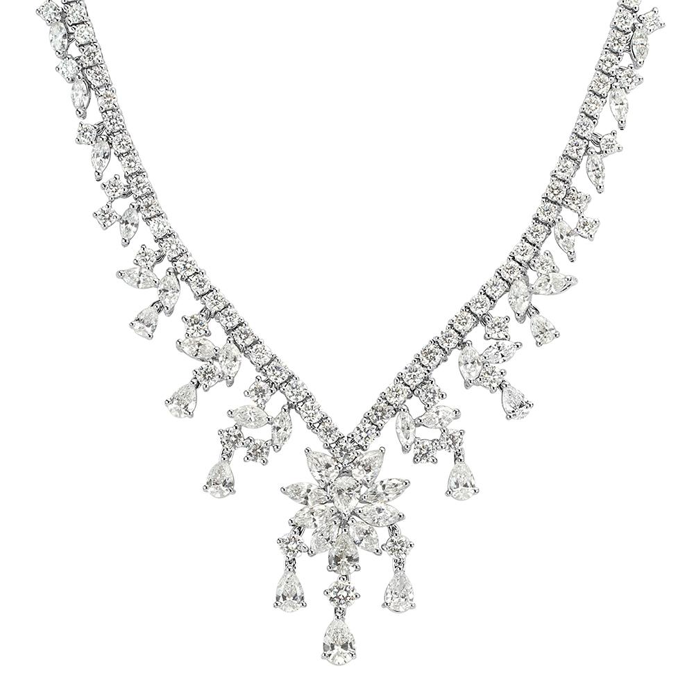 Delightful in every way, this enchanting cluster diamond necklace features a trio of pear shaped, marquise and round brilliant cut diamonds expertly hand set in 18k white gold. The diamonds total 16.02ct in weight and are graded at E-F colors,
