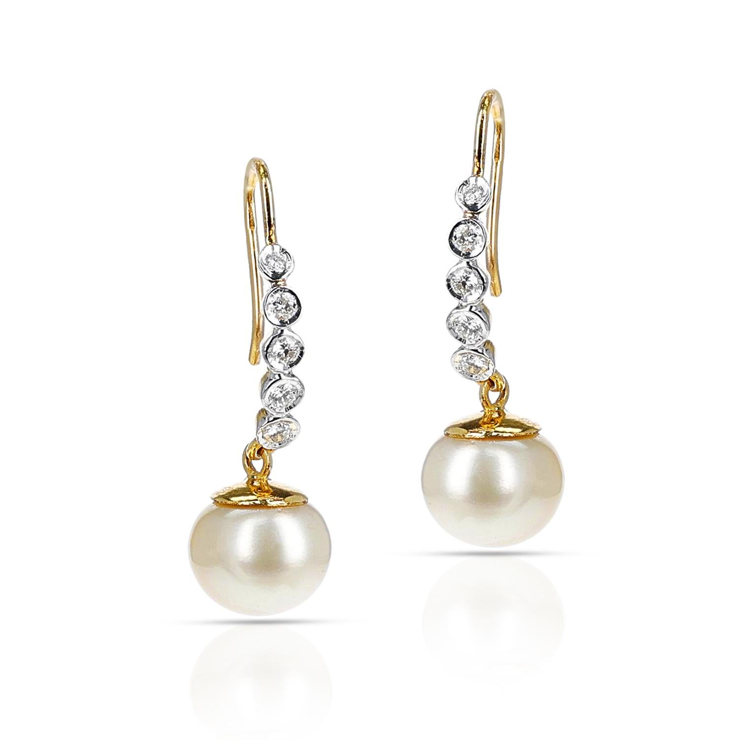 A pair of South Sea Pearl Dangling Earrings with Diamonds made in 14 Karat Yellow Gold. The weight of the pearls is 16.06 carats and the total weight of the diamonds is 0.43 carats. The total weight of the earrings is 6.62 grams. Matching pendant