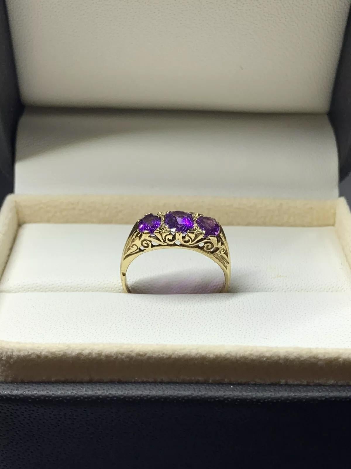 This beautiful antique engagement ring features a stunning oval-shaped amethyst as the main stone, with a total carat weight of 1.60. The ring is made of 9ct yellow gold and has a three-stone setting style, with a valuation certification for added