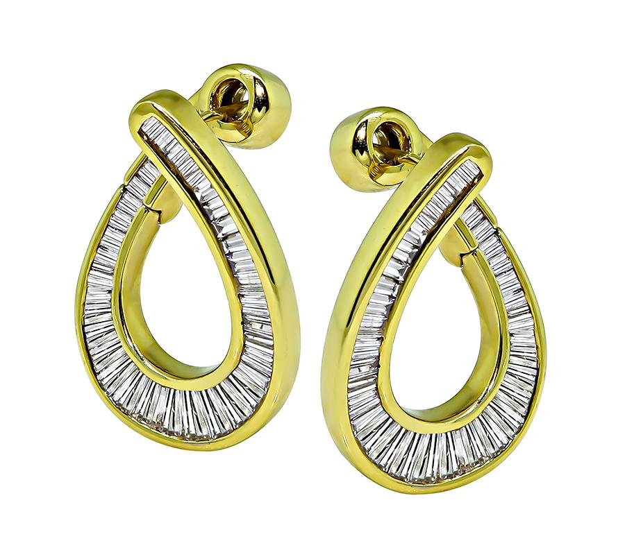 This is a stunning pair of 18k yellow gold earrings. The earrings feature sparkling baguette cut diamonds that weigh approximately 1.60ct. The color of these diamonds is G-H with VS clarity. The earrings measure 25mm by 17.5mm and weigh 10.9
