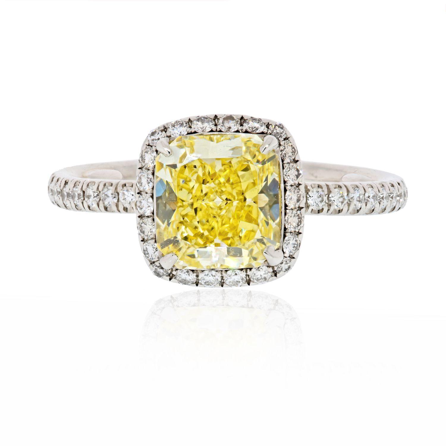 This is a beautiful natural fancy yellow cushion cut diamond engagement ring crafted in platinum mounted in the original Harry Winston pave diamond Setting. 

Center diamond is a 1.60 Carat GIA Certified Natural Fancy Yellow VVS2 clarity diamond of