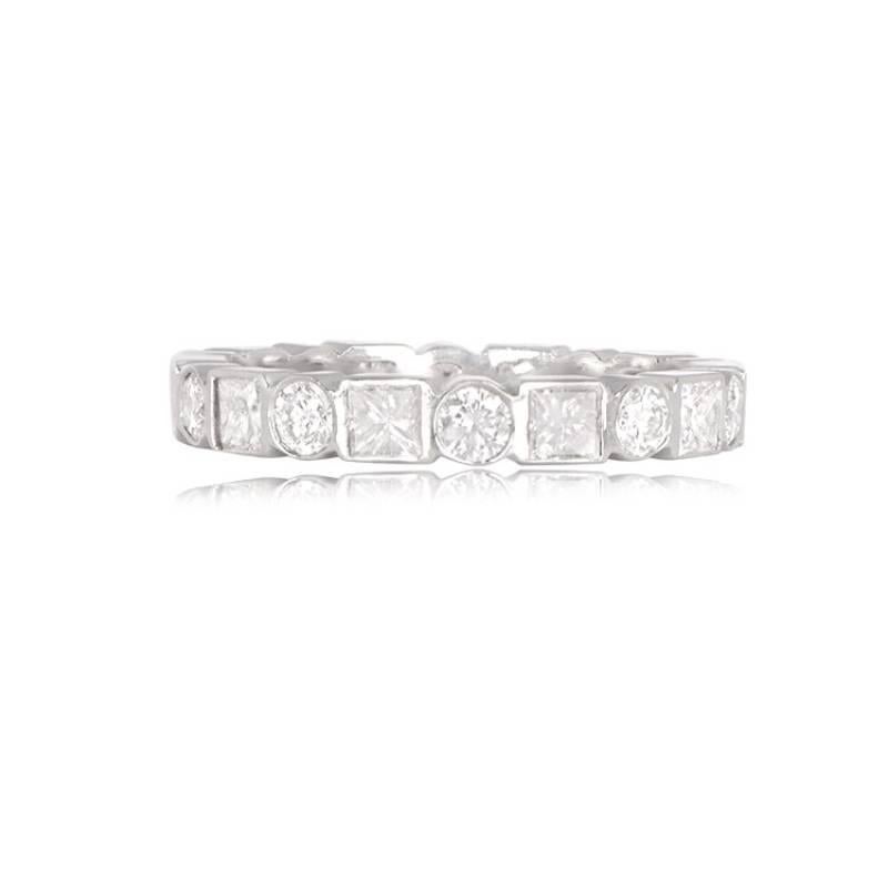 Experience sophistication with this platinum bezel ring adorned with alternating round brilliant cut diamonds and princess cut diamonds encircling the band. The total weight of the diamonds is approximately 1.60 carats, showcasing exquisite