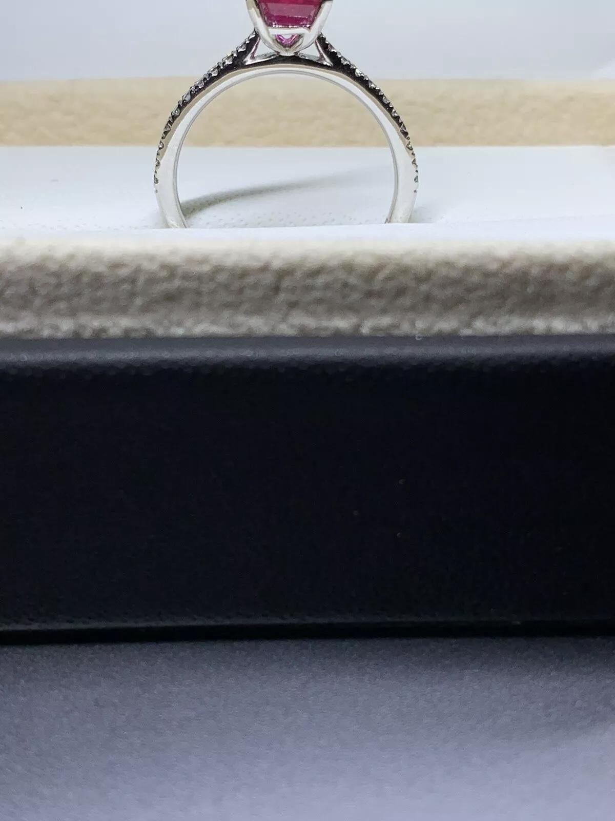 1.60ct Ruby and diamond engagement ring in 18k white gold.

Ruby emerald shape gemstone natural untreated total weight 1.35ct

Emerald shaped intense vivid ruby gemstone on a diamond pave band.

Diamonds total weight 0.25ct F colour VS1