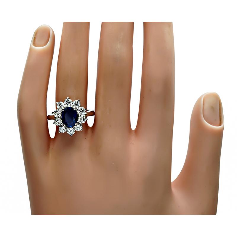 This is a gorgeous platinum engagement ring. The ring is centered with a lovely oval cut sapphire that weighs approximately 1.60ct. The sapphire is accentuated by sparkling round cut diamonds that weigh approximately 1.50ct. The color of these