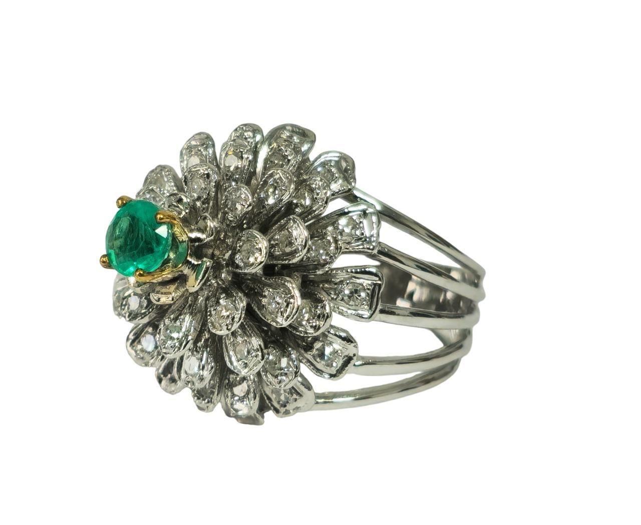At its heart lies a mesmerizing Colombian emerald, symbolizing growth and prosperity, surrounded by a halo of side diamonds, each boasting impeccable clarity and color. This ring's exquisite flower and blooming design is more than just jewelry; it's