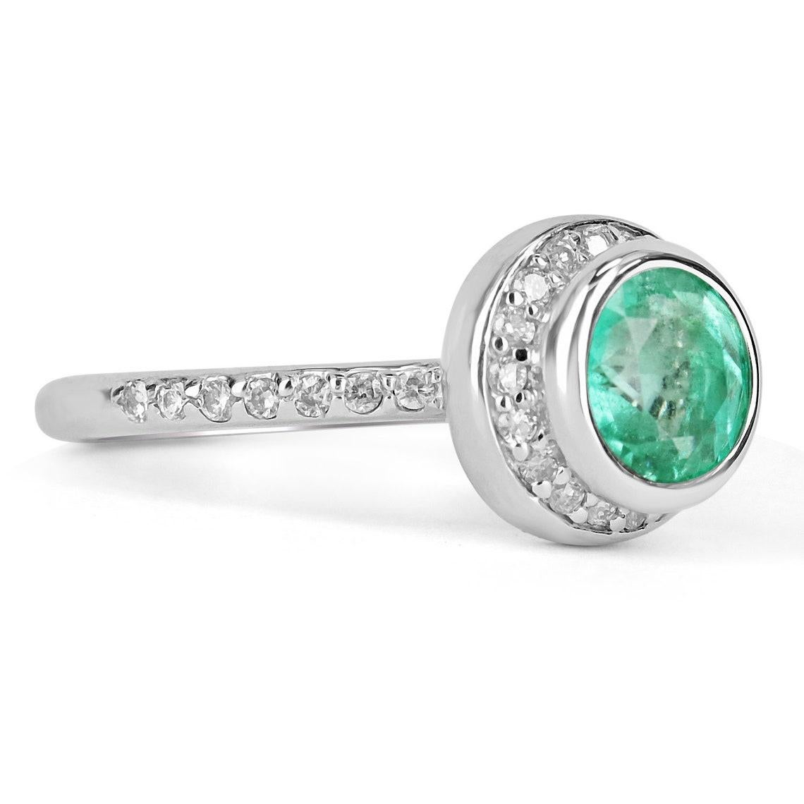 This is a very rare, round Colombian emerald and diamond halo ring. a luminous, round emerald has vivacious color and incredible transparency that make it exclusive. The emerald is securely bezel set and is accented with round diamonds in a halo