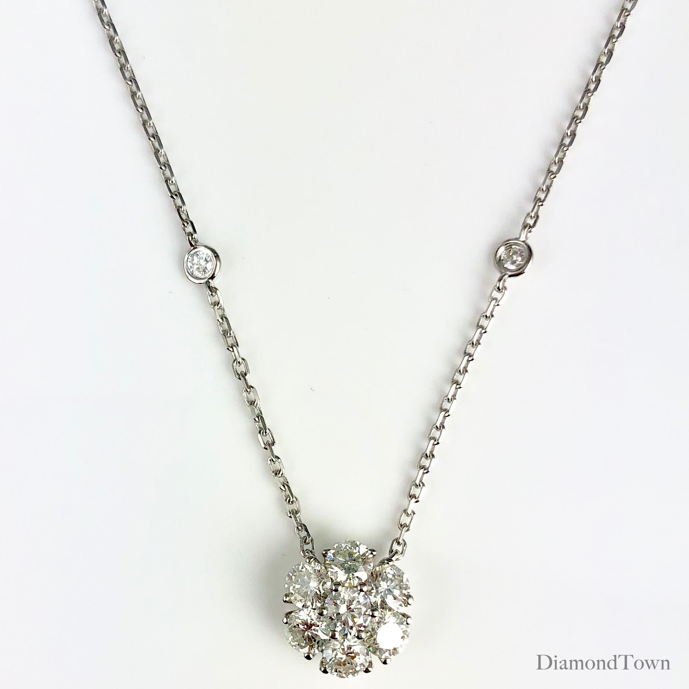 (DiamondTown) This lovely pendant features seven round diamonds arranged in a flower shape (diamond weight 1.33 carats). Eight additional diamonds placed along the chain bring the total diamond weight to 1.61 carats.

Chain measures 17